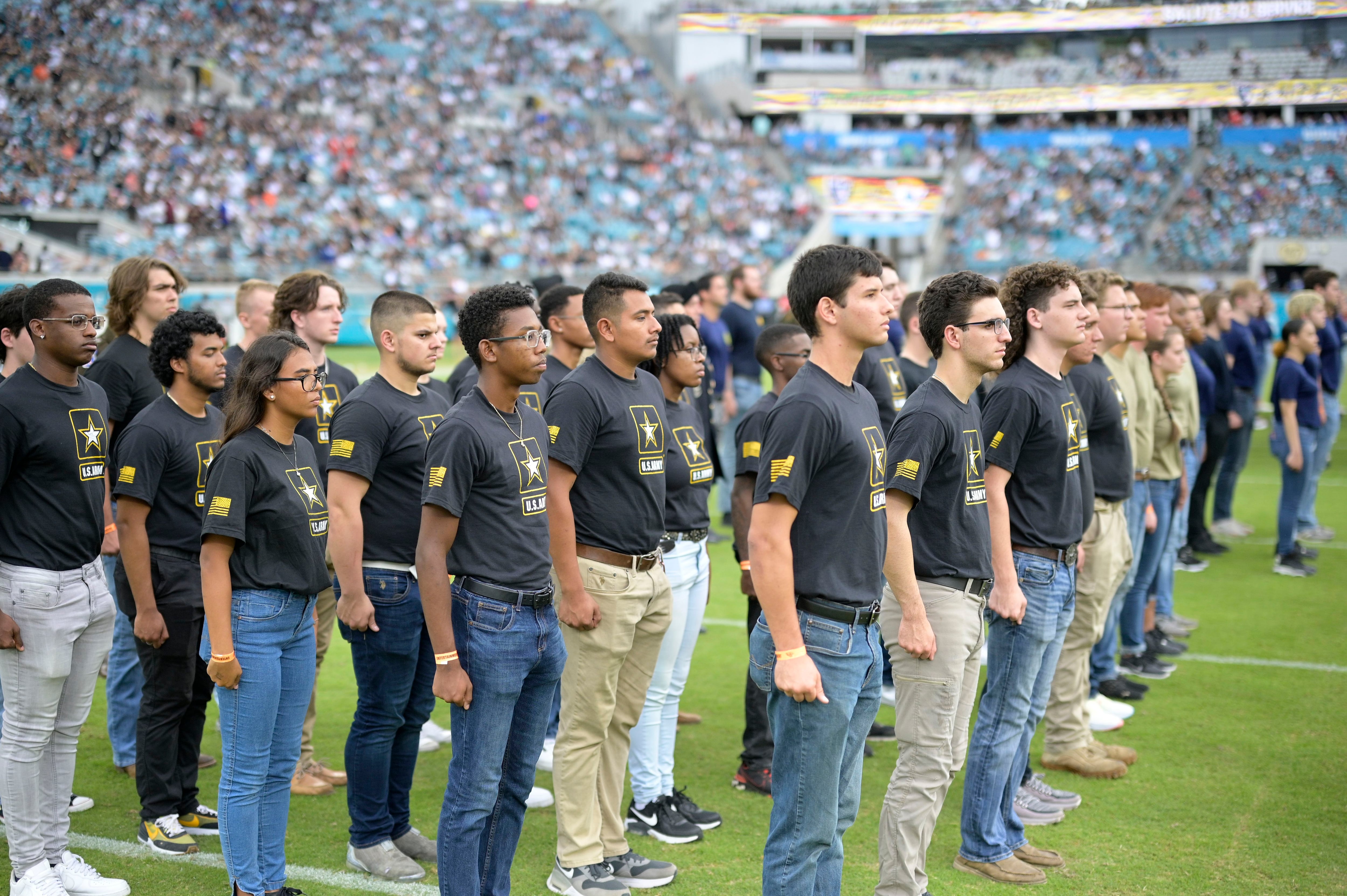 U.S. Air Force recruits are sworn in during halftime on Salute to Service  military appreciation day at an NFL football game between the Jacksonville  Jaguars and the Las Vegas Raiders, Sunday, Nov.