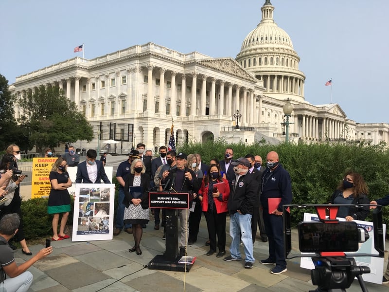 Comedian Jon Stewart (center) speaks to a crowd of reporters and advocates about benefits for veterans who suffer from illnesses related to exposure to war zone burn pits during a Capitol Hill rally on Sept. 15, 2020. (Leo Shane III/Staff)