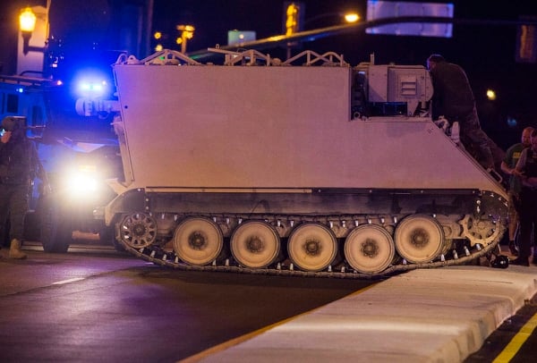 Emergency personnel surround a National Guard military vehicle stolen from Fort Pickett, Va., on June 5, 2018. Police said they arrested a soldier who stole the armored personnel carrier after chasing him for more than 60 miles. (Grace Hollars/Richmond Times-Dispatch via AP)