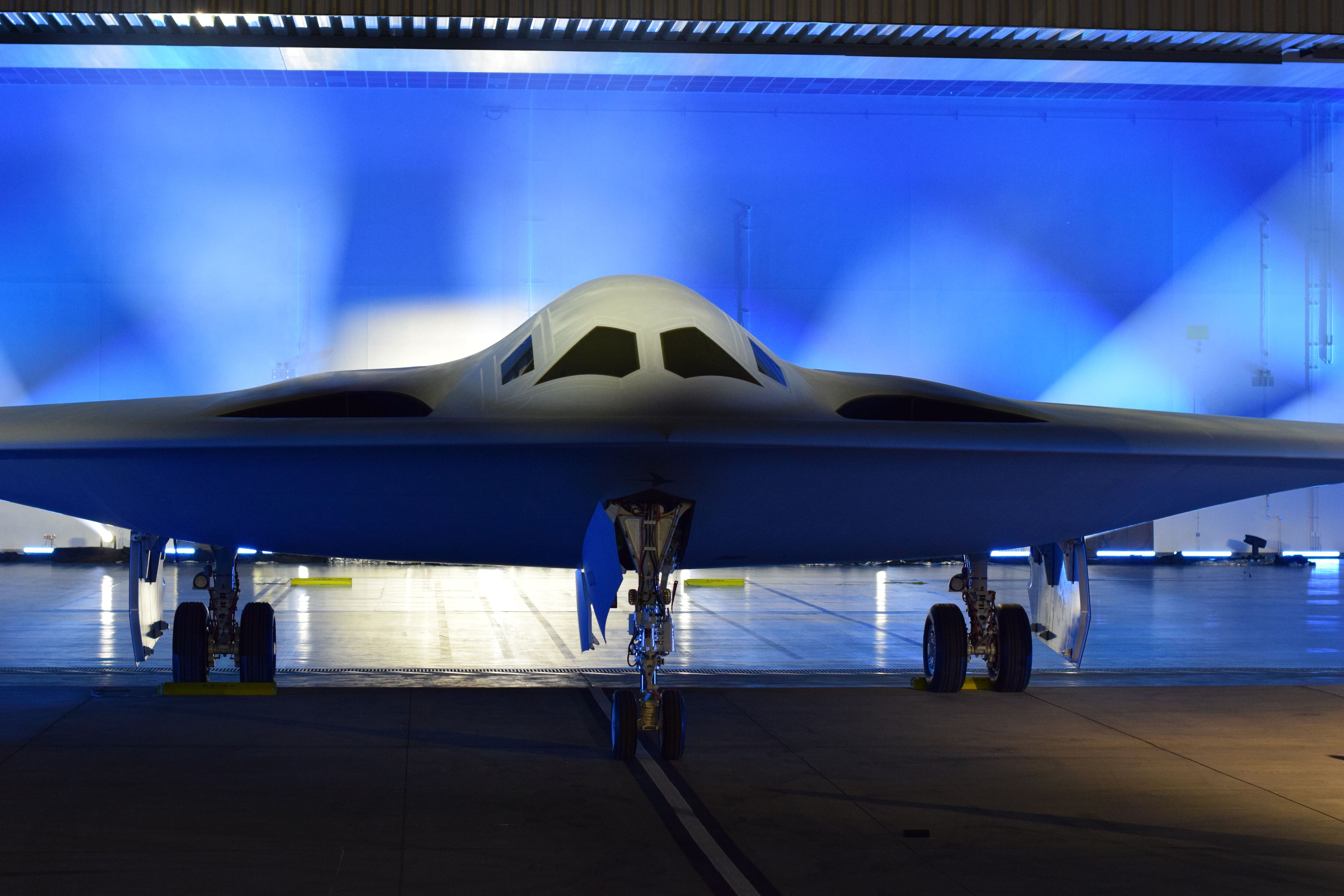 The first B-21 Raider rolls out of a hangar at Air Force Plant 42 in Palmdale, Calif., in a ceremony attended by Defense Secretary Lloyd Austin, military leaders and lawmakers, and the families of some Doolittle Raiders for whom the bomber is named. (Stephen Losey/Staff)
