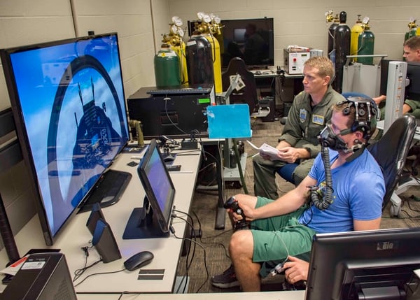 Navy Lt. Clayton Shaw, an instructor pilot with Training Squadron 10, helps test equipment meant to provide early warning signs to pilots before they feel the effects of hypoxia. (Mass Communication Specialist 2nd Class Michael J. Lieberknecht/Navy)