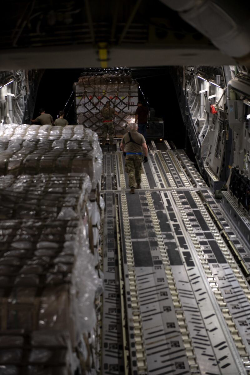 U.S. Airmen assigned to the 60th Aerial Port Squadron secure pallets loaded with American-made ventilators onto the cargo floor of a C-17 Globemaster III on Aug. 27, 2020 at Travis Air Force Base, California. (U.S. Air Force photo by Senior Airman Jonathon Carnell)