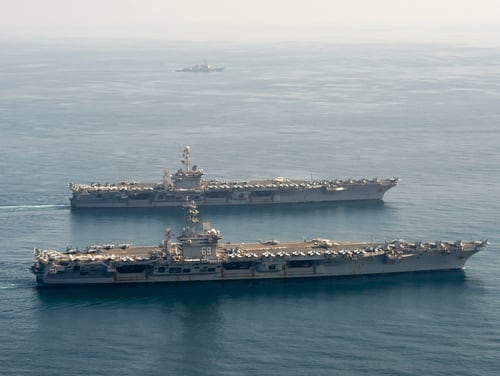 The U.S. Navy aircraft carriers Dwight D. Eisenhower and Harry S. Truman navigate the Arabian Sea. (Seaman Maxwell Higgins/U.S. Navy)