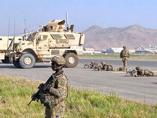 U.S soldiers stand guard along a perimeter at the international airport in Kabul, Afghanistan, Monday, Aug. 16, 2021. (AP Photo/Shekib Rahmani)