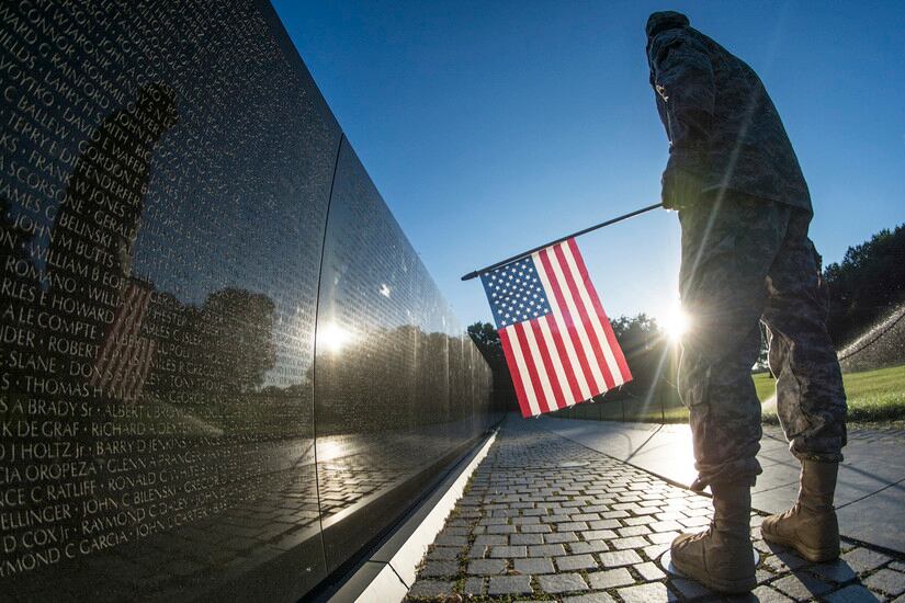 Soldier at the Vietnam Memorial wall