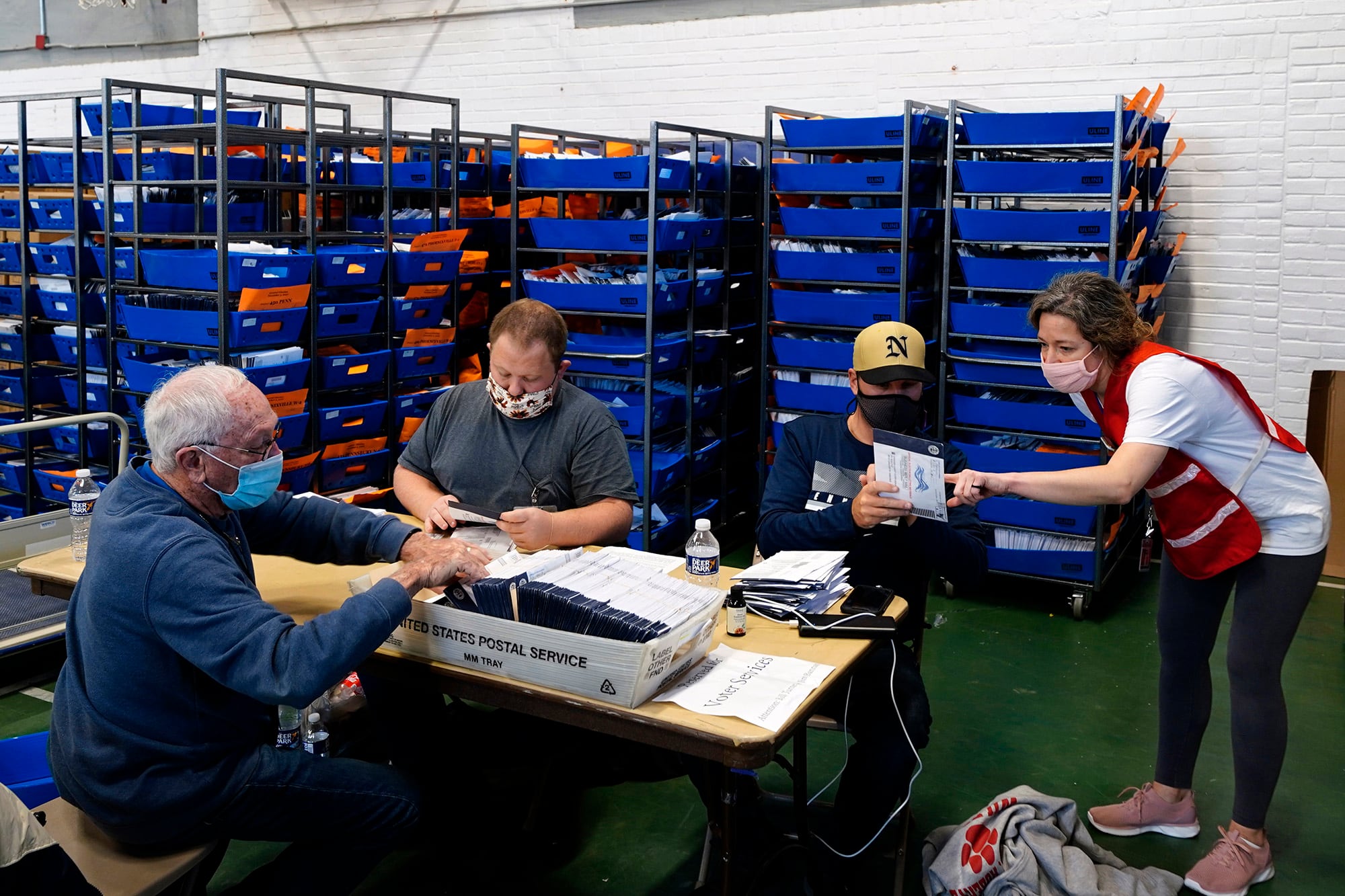 Chester County, Pa., election workers process mail-in and absentee ballots for the 2020 general election in the United States at West Chester University, Wednesday, Nov. 4, 2020, in West Chester, Pa