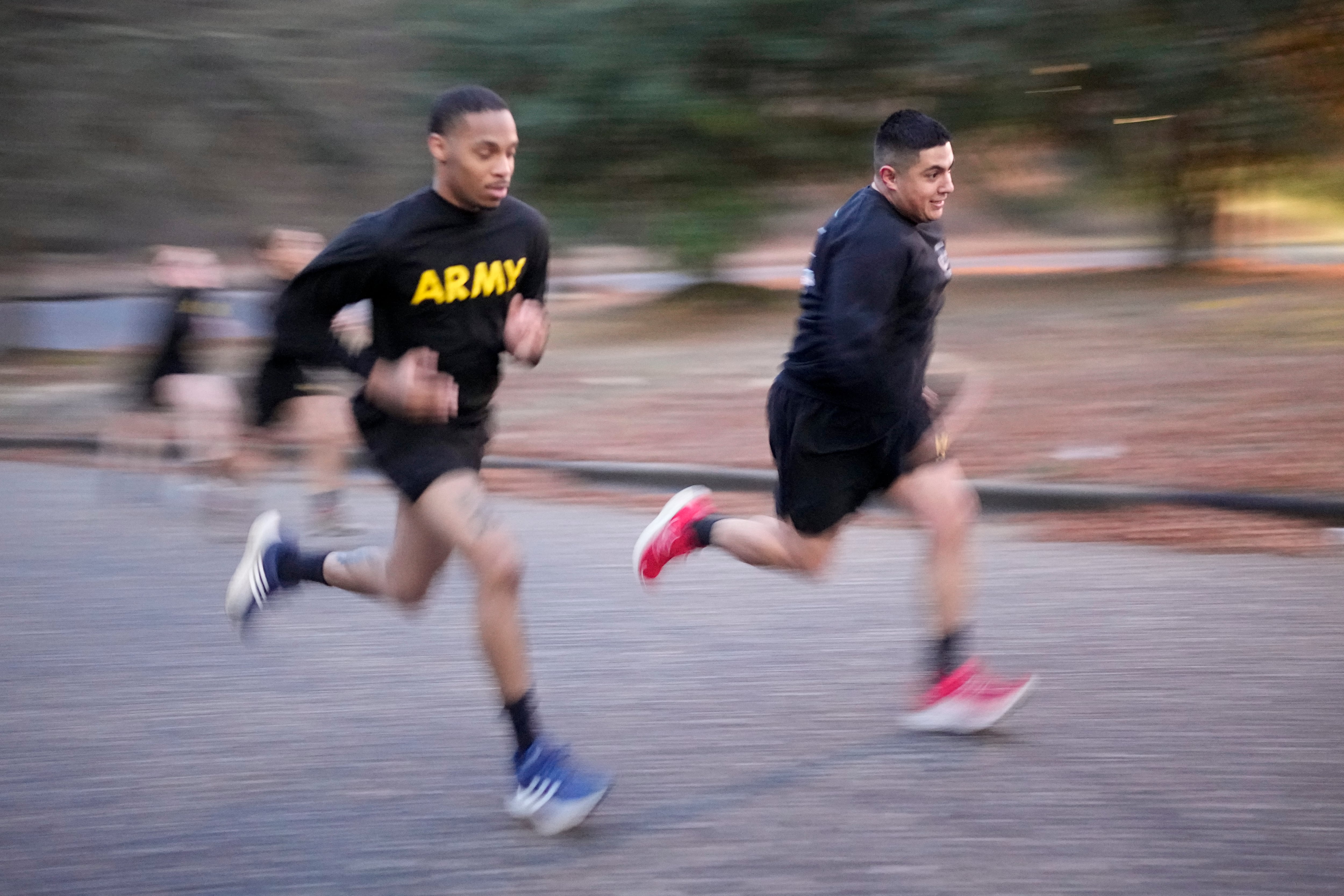 Army Staff Sgt. Daniel Murillo, right, runs up hill as part of his physical training at Ft. Bragg on Wednesday, Jan. 18, 2023, in Fayetteville, N.C.