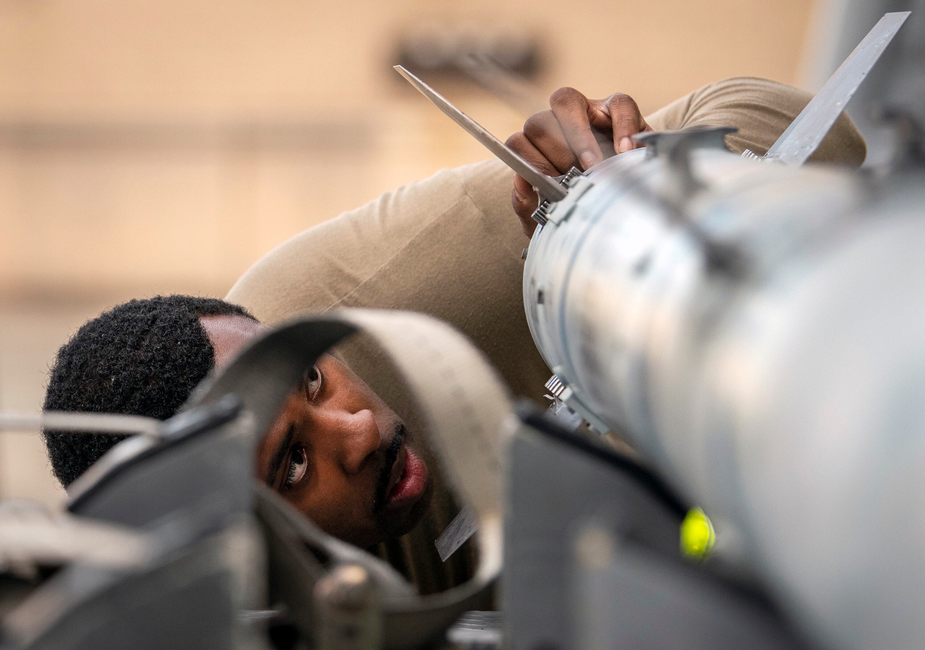 Staff Sgt. Donoven Wright, 43rd Fighter Generation Squadron, checks AIM-120 fins during the unit’s weapons load competition Feb. 11 at Eglin Air Force Base, Fla. (Samuel King Jr./Air Force)