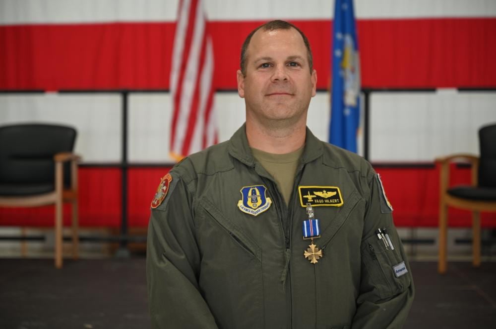 Maj. Mike “Vago” Hilkert, an A-10 Thunderbolt II pilot with the 303rd Fighter Squadron, is awarded the Distinguished Flying Cross Oct. 2, 2021, in the 5-Bay hangar on Whiteman Air Force Base, Mo. Hilkert received the award for actions taken on a combat search-and-rescue mission in 2011 in the Kapisa province of Afghanistan. (Staff Sgt. Kristin Cerri/Air Force)