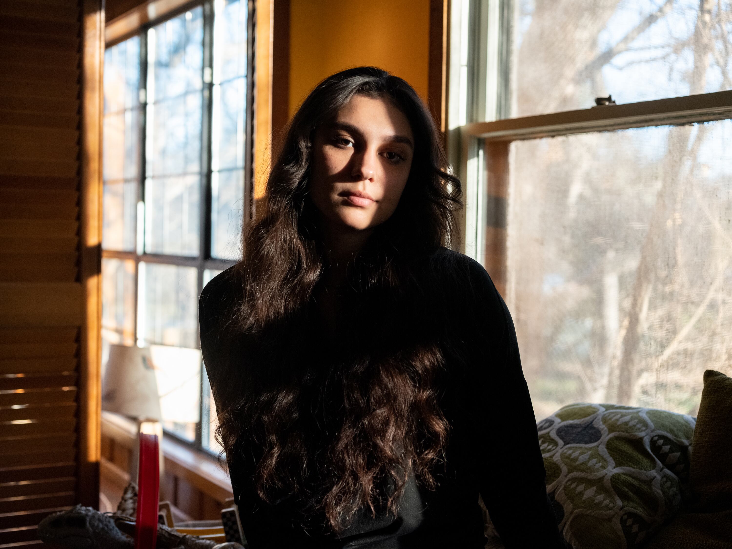 Olivia Ochoa stands by a window