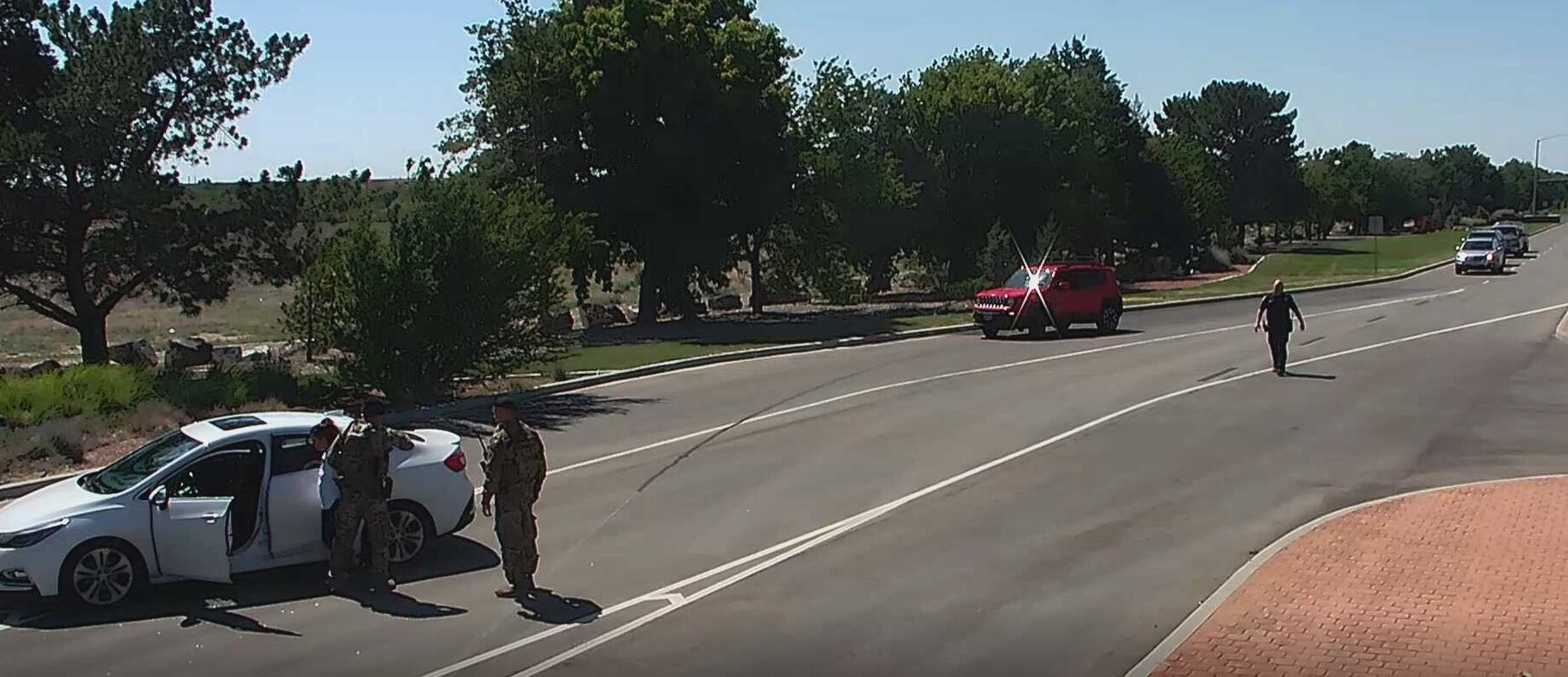 A screenshot of closed-circuit television footage of a June 26, 2021, incident provided by Mountain Home Air Force Base, Idaho, shows Tati Gonzalez being handcuffed after security forces Tech. Sgt. Ryan Green breaks her car window with a baton.