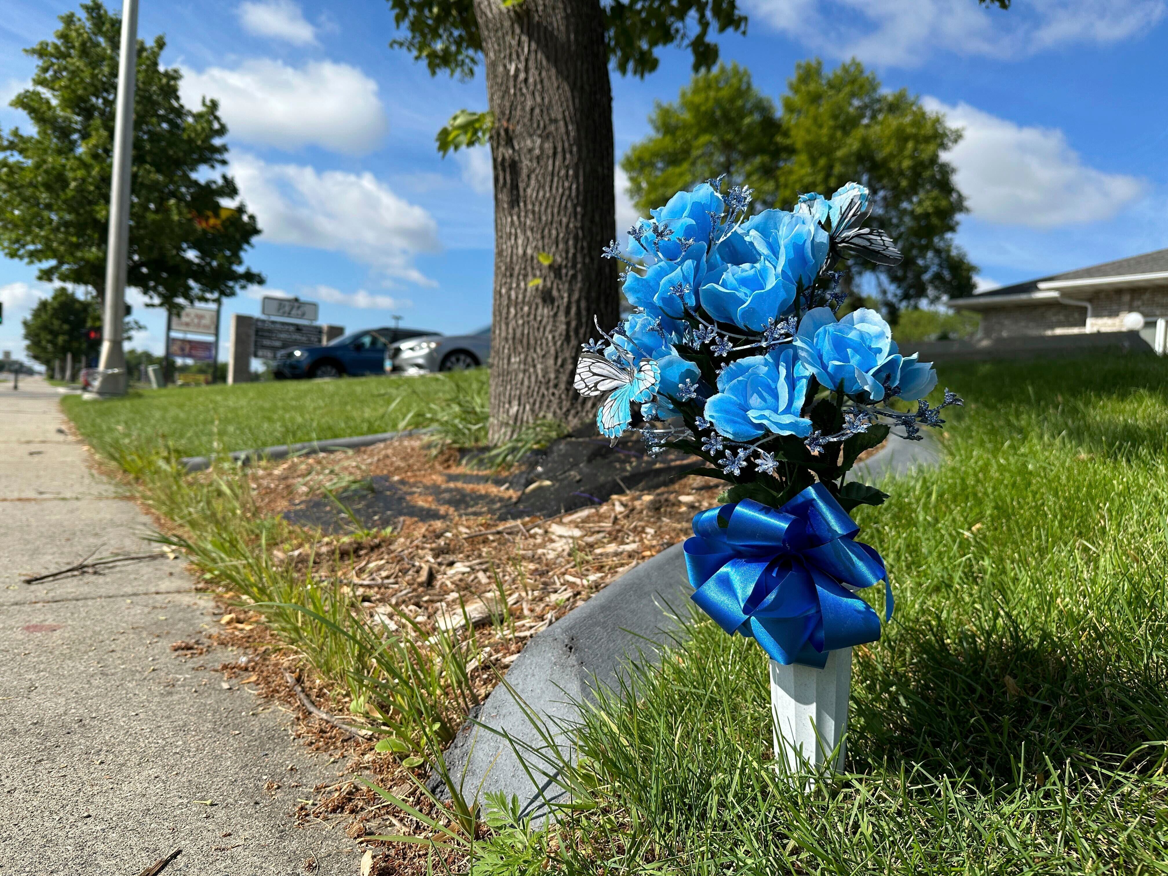 Flowers rest near the scene, Saturday, July 15, 2023, in Fargo, N.D., where one police officer was fatally shot and two others were critically wounded Friday, July 14.