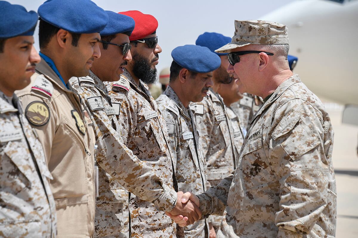 Marine Corps Gen. Kenneth F. McKenzie Jr., the commander of U.S. Central Command, right, shakes hands with airmen of the Royal Saudi Air Force on Prince Sultan Air Base, July 18, 2019.