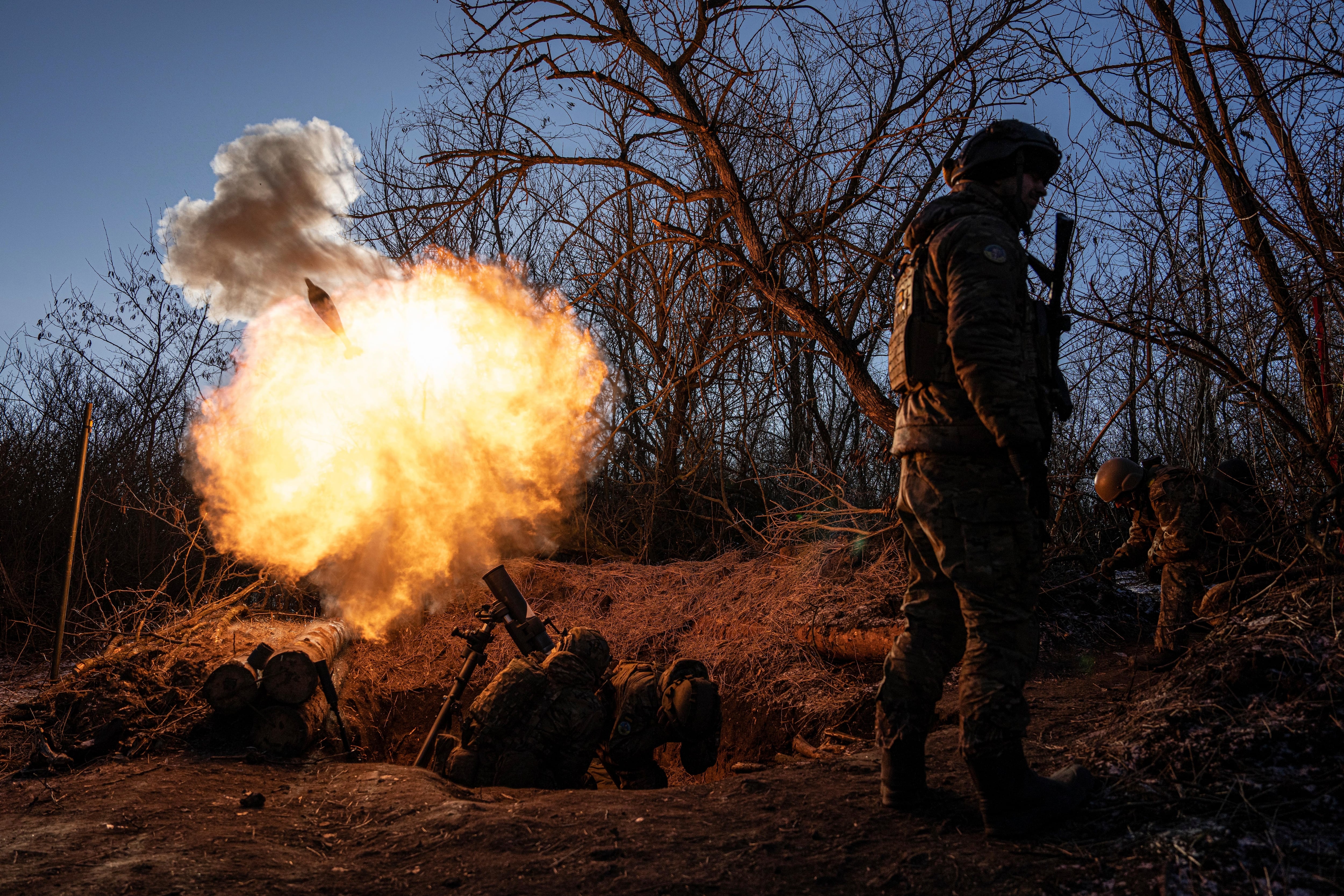 Ukrainian servicemen fire a 120mm mortar towards Russian positions at the frontline near Bakhmut, Donetsk region, Ukraine, Wednesday, Jan. 11, 2023.