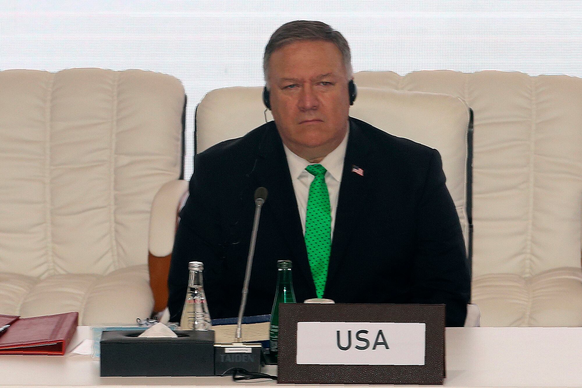 U.S. Secretary of State Mike Pompeo listens through his headphone at the opening session of the peace talks between the Afghan government and the Taliban in Doha, Qatar, Saturday, Sept. 12, 2020.