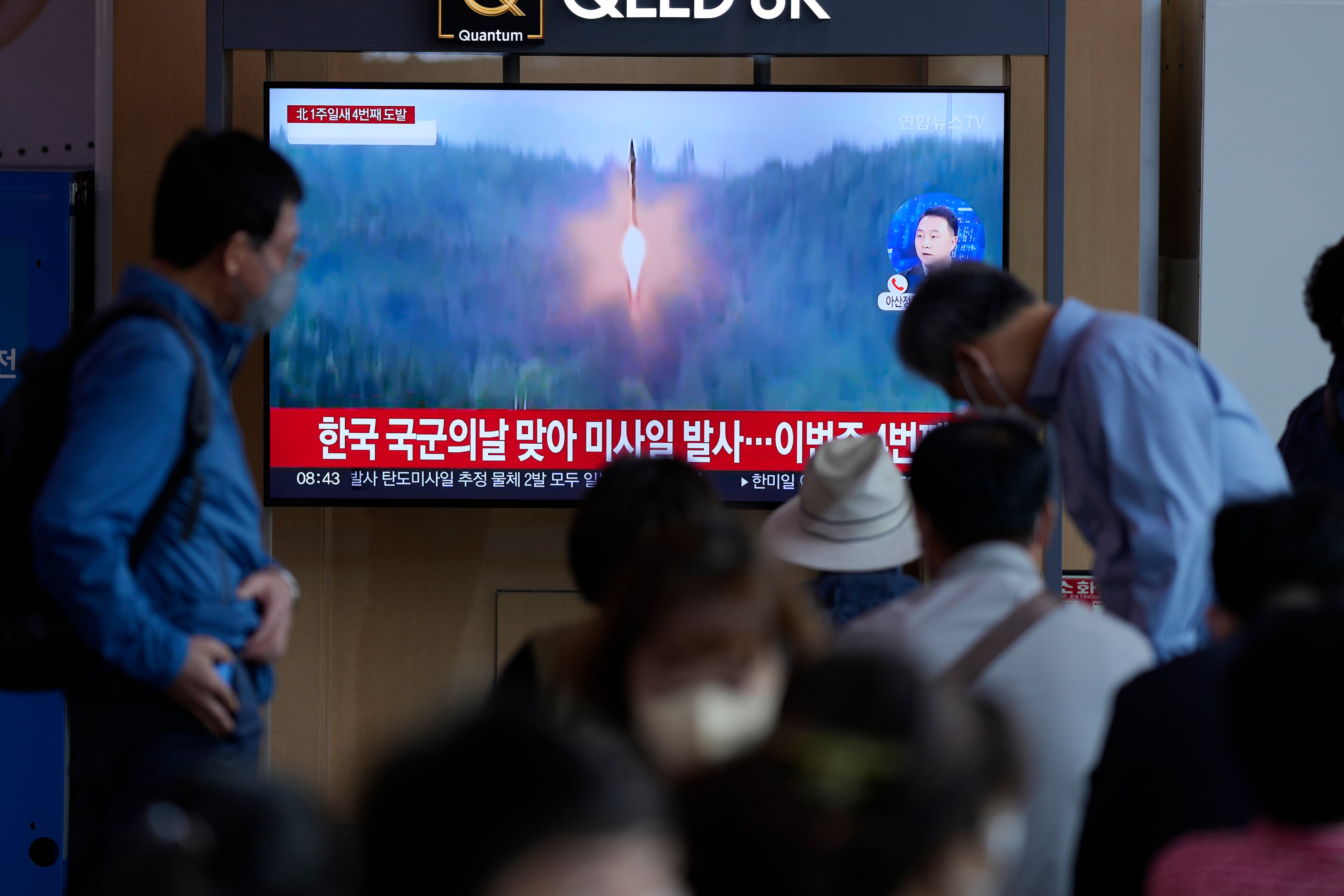 A TV screen showing a news program reporting about North Korea's missile launch with file footage, is seen at the Seoul Railway Station in Seoul, South Korea, Saturday, Oct. 1, 2022.