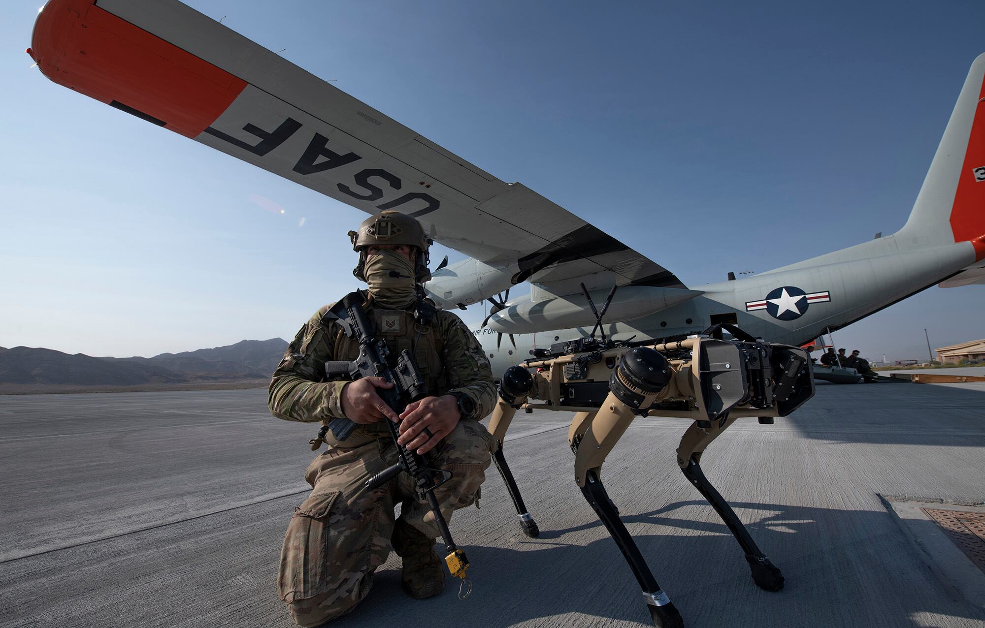 Tech. Sgt. John Rodiguez provides security with a Ghost Robotics Vision 60 prototype at a simulated austere base during the Advanced Battle Management System exercise on Nellis Air Force Base, Nev., Sept. 1, 2020.