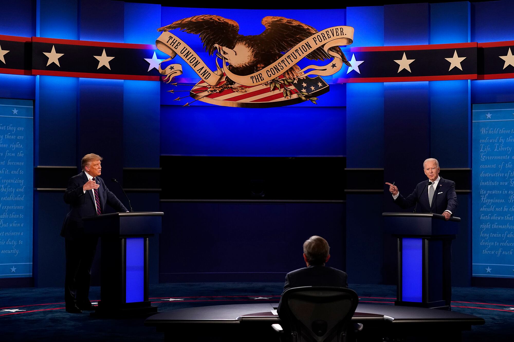 President Donald Trump, left, and Democratic presidential candidate former Vice President Joe Biden, right, with moderator Chris Wallace, center, of Fox News during the first presidential debate Tuesday, Sept. 29, 2020, at Case Western University and Cleveland Clinic, in Cleveland.