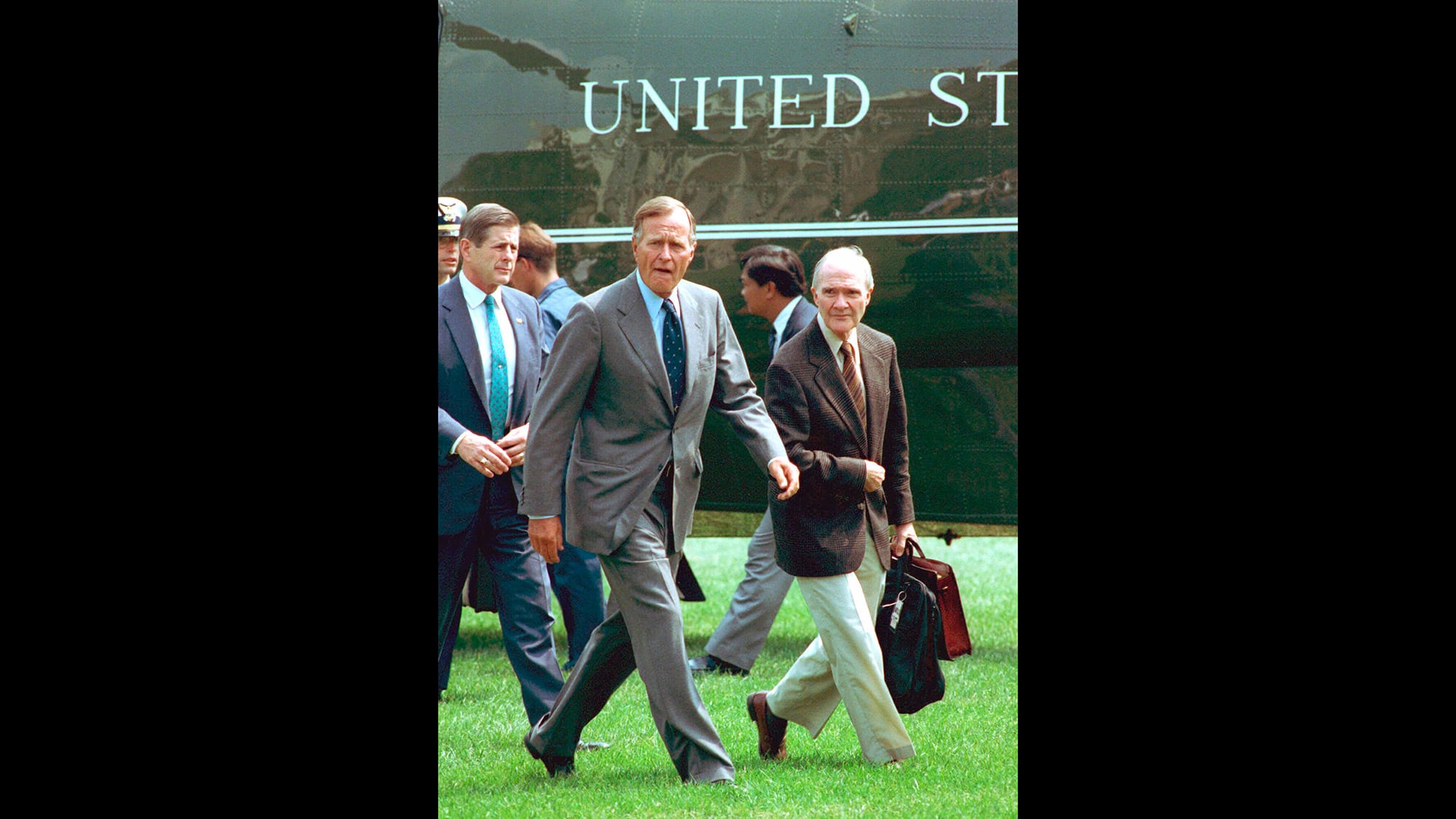 In this August 19, 1991, file photo, President George Bush, accompanied by national security adviser Brent Scowcroft, right, arrives back at the White House after he interrupted his vacation following the overthrow of Soviet President Gorbachev.