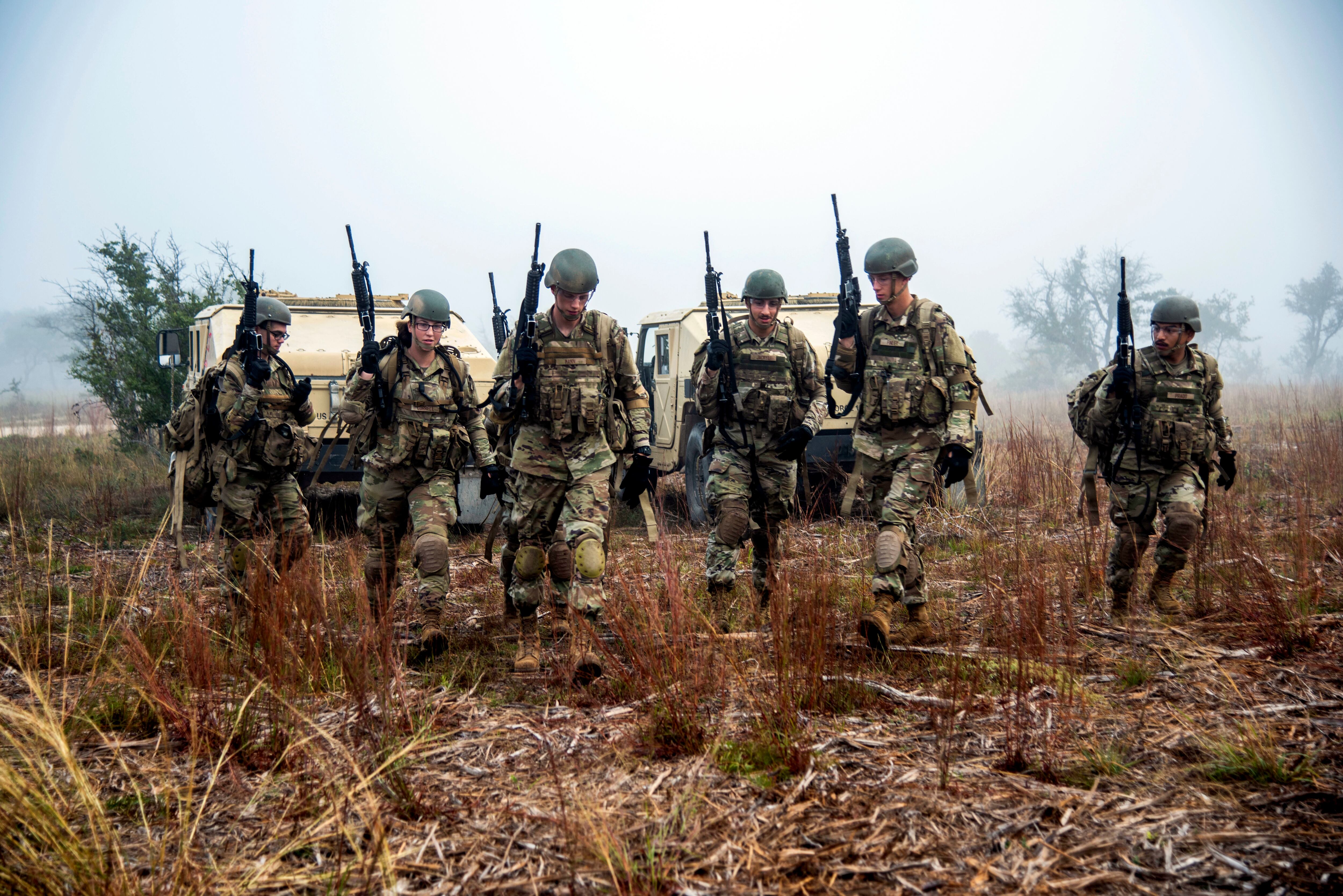 Air Force security forces trainees patrol a field