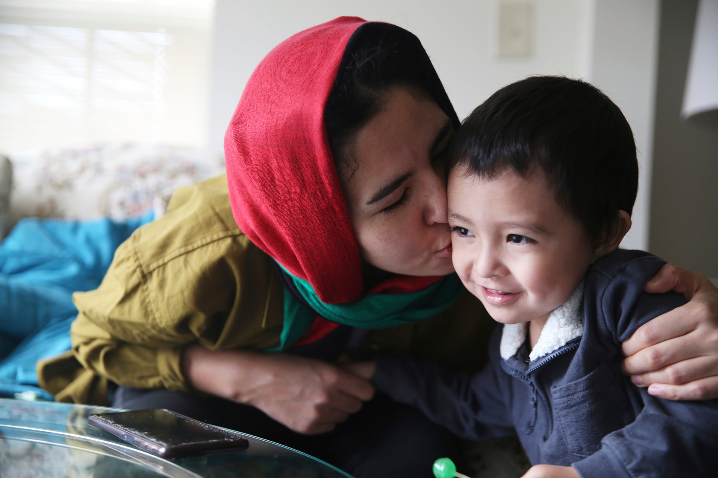 Sima Gul shares a moment with her son, Amir Mazlom Yar in their Blacksburg, Va., apartment on Feb. 9, 2023.