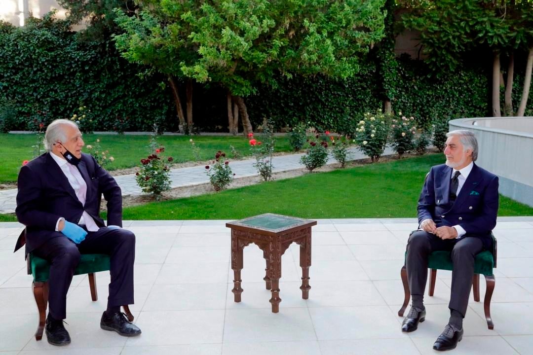 In this Wednesday, May 20, 2020, photo, Abdullah Abdullah, right, President Ashraf Ghani's fellow leader under a recently signed power-sharing agreement, holds a meeting with U.S. peace envoy Zalmay Khalilzad aimed at resuscitating a U.S.-Taliban peace deal signed in February, at the presidential palace, in Kabul, Afghanistan.