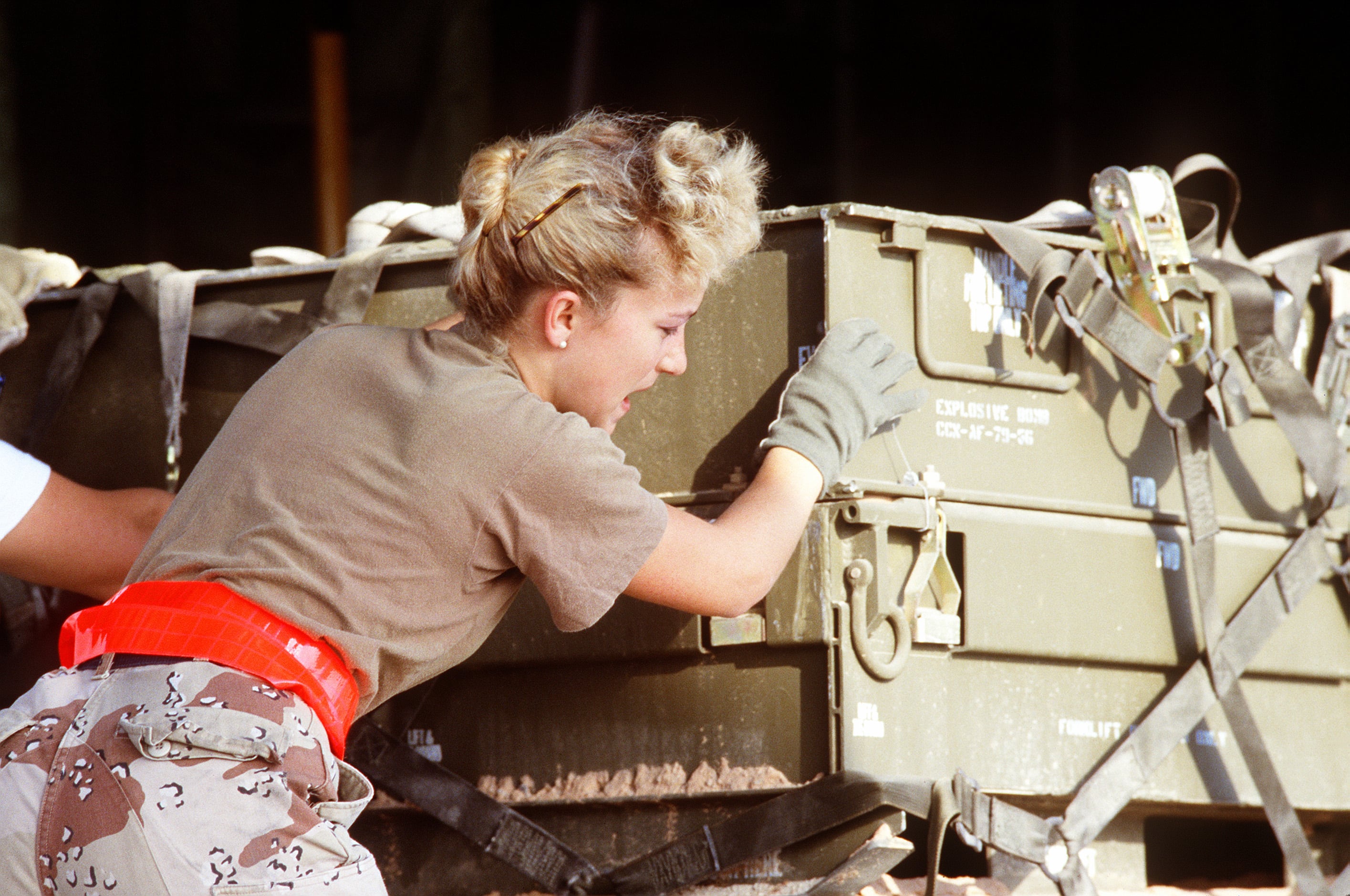 An airman moves equipment during Desert Storm.