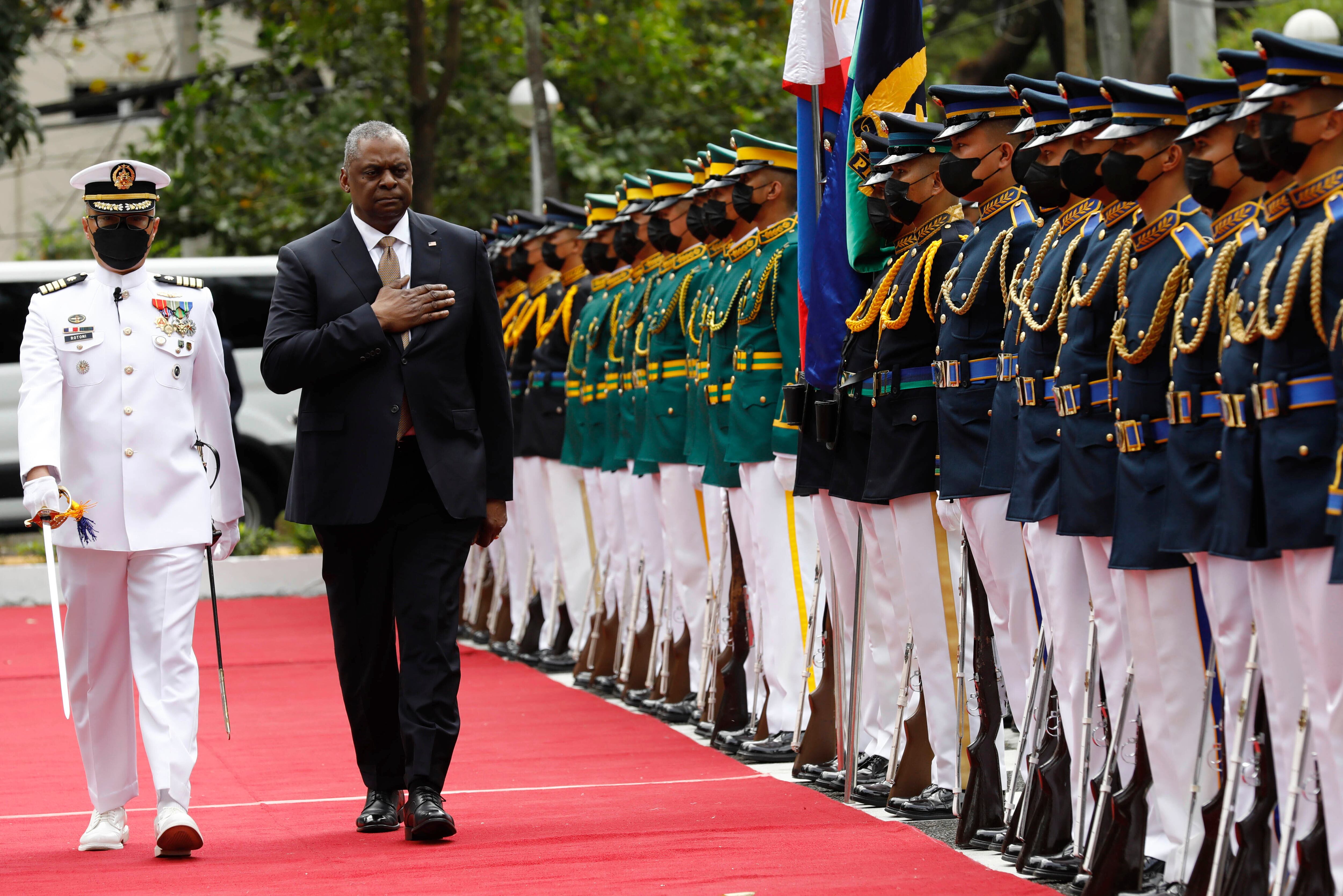 U.S. Defense Secretary Lloyd Austin, second from left, walks past military guards during his arrival at the Department of National Defense in Camp Aguinaldo military camp in Quezon City, Metro Manila, Philippines on Thursday February 2, 2023.