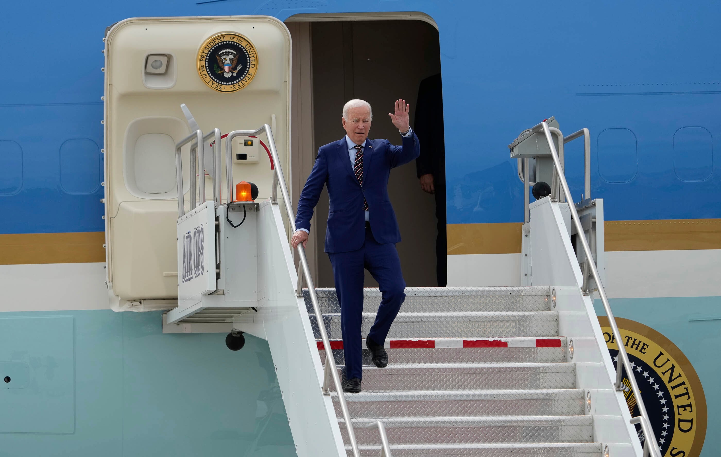 President Joe Biden exits Air Force One after landing at Roland R. Wright Air National Guard Base, Wednesday, Aug. 9, 2023, in Salt Lake City.