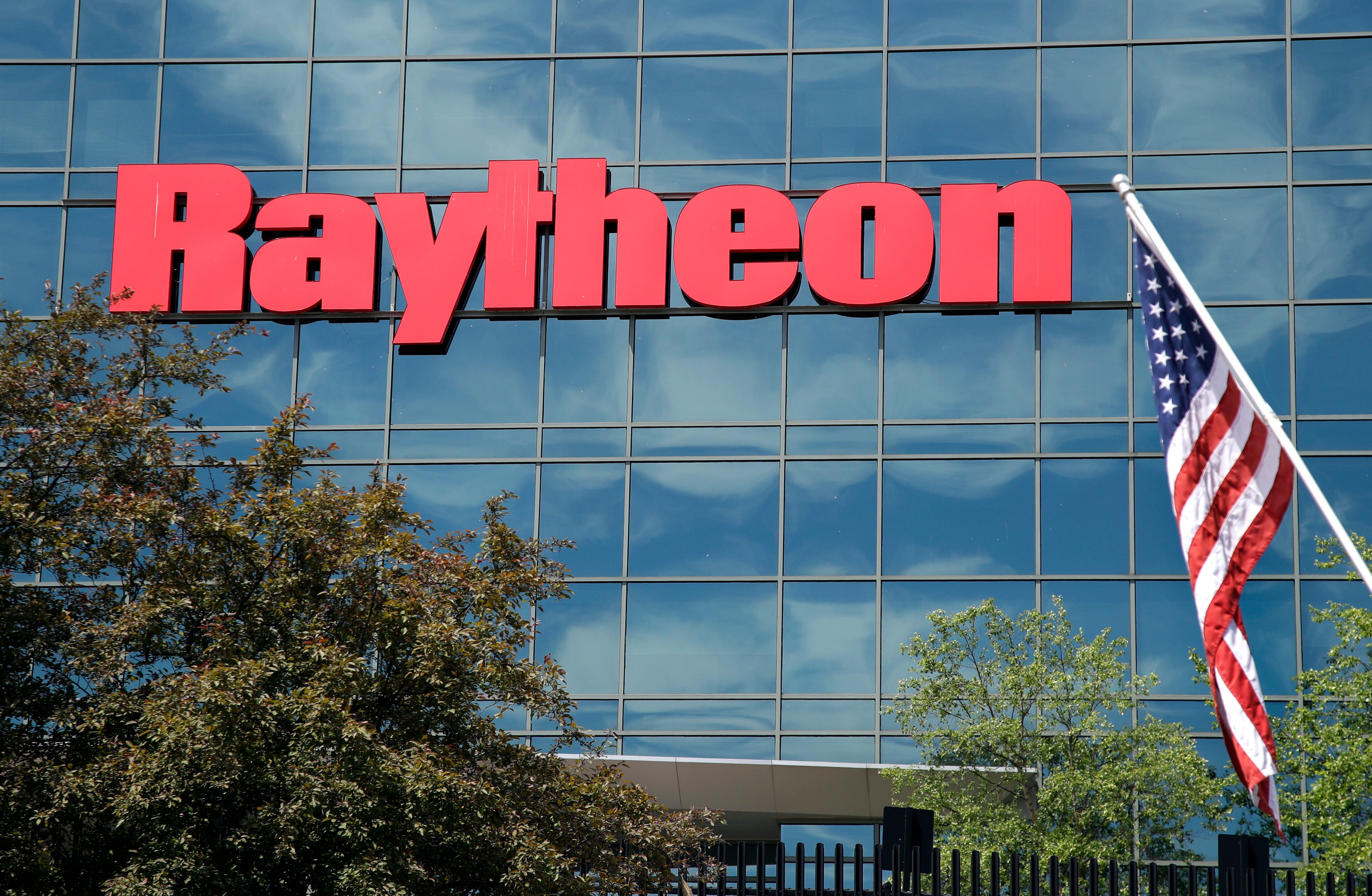 An American flag flies in front of the facade of Raytheon's Integrated Defense Systems facility in Woburn, Mass., June 10, 2019.