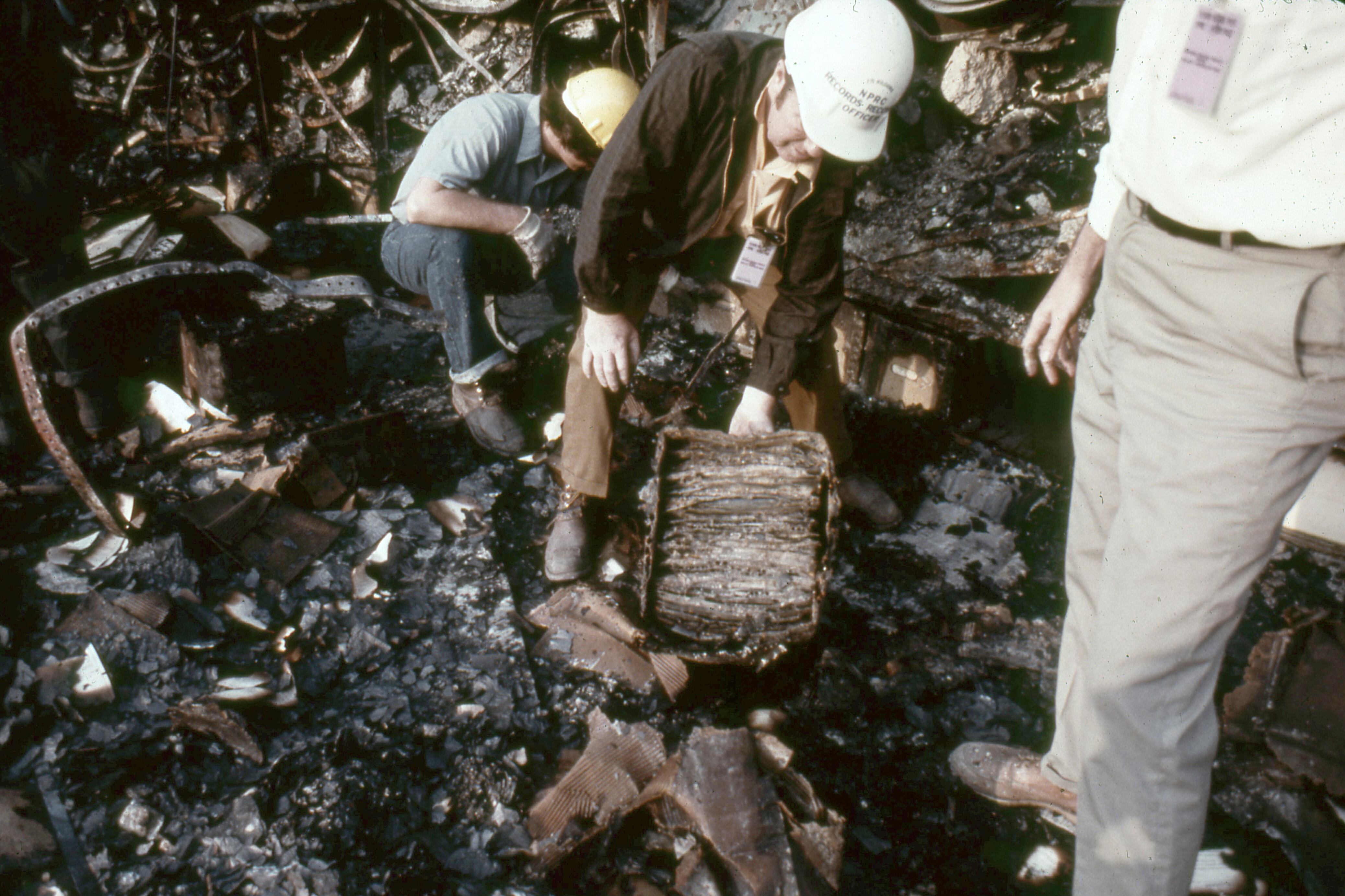 In this photo provided by the National Archives and Records Administration, records from the sixth floor of the Military Personnel Records Center in Overland, Mo., near St. Louis, are recovered months after the massive fire that started on July 12, 1973. The box was soaked in water and covered completely with mold.