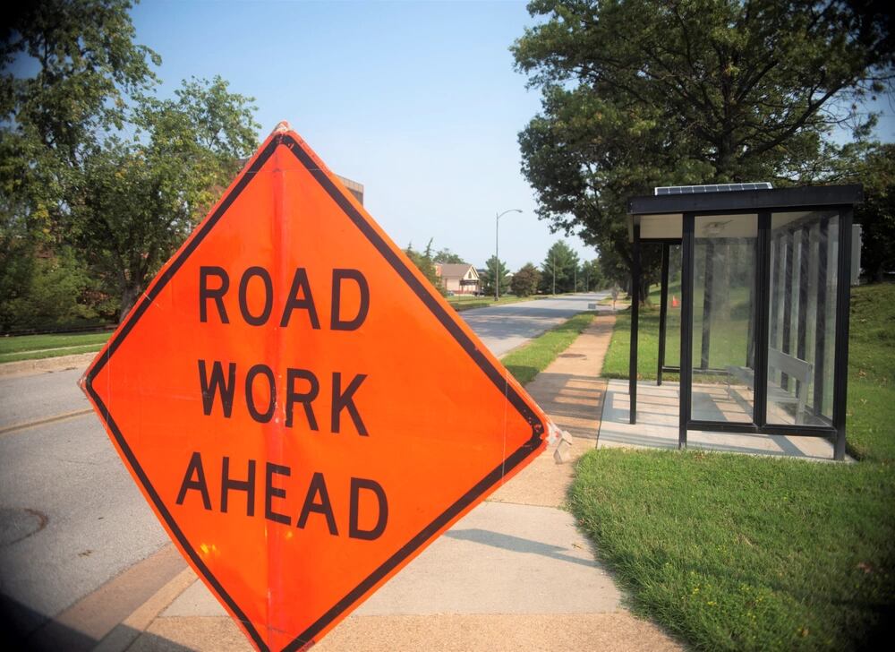 A "road work ahead" sign on the sidewalk ahead of Theisen Street near the Bolling Club at Joint Base Anacostia-Bolling, Sept 13, 2021. The makeover of the road and parking lot outside of the Bolling Club is only one part of the $2 million base-wide paving project. In the last year and half, infrastructure improvement and maintenance has been a priority for the 11th Civil Engineer Squadron. (2nd Lt. Brandon DeBlanc/Air Force)