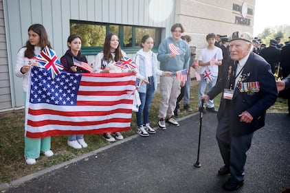 Children greet war veterans arriving for ceremony at the Pegasus Bridge memorial in Benouville, Normandy, Monday June 5, 2023.