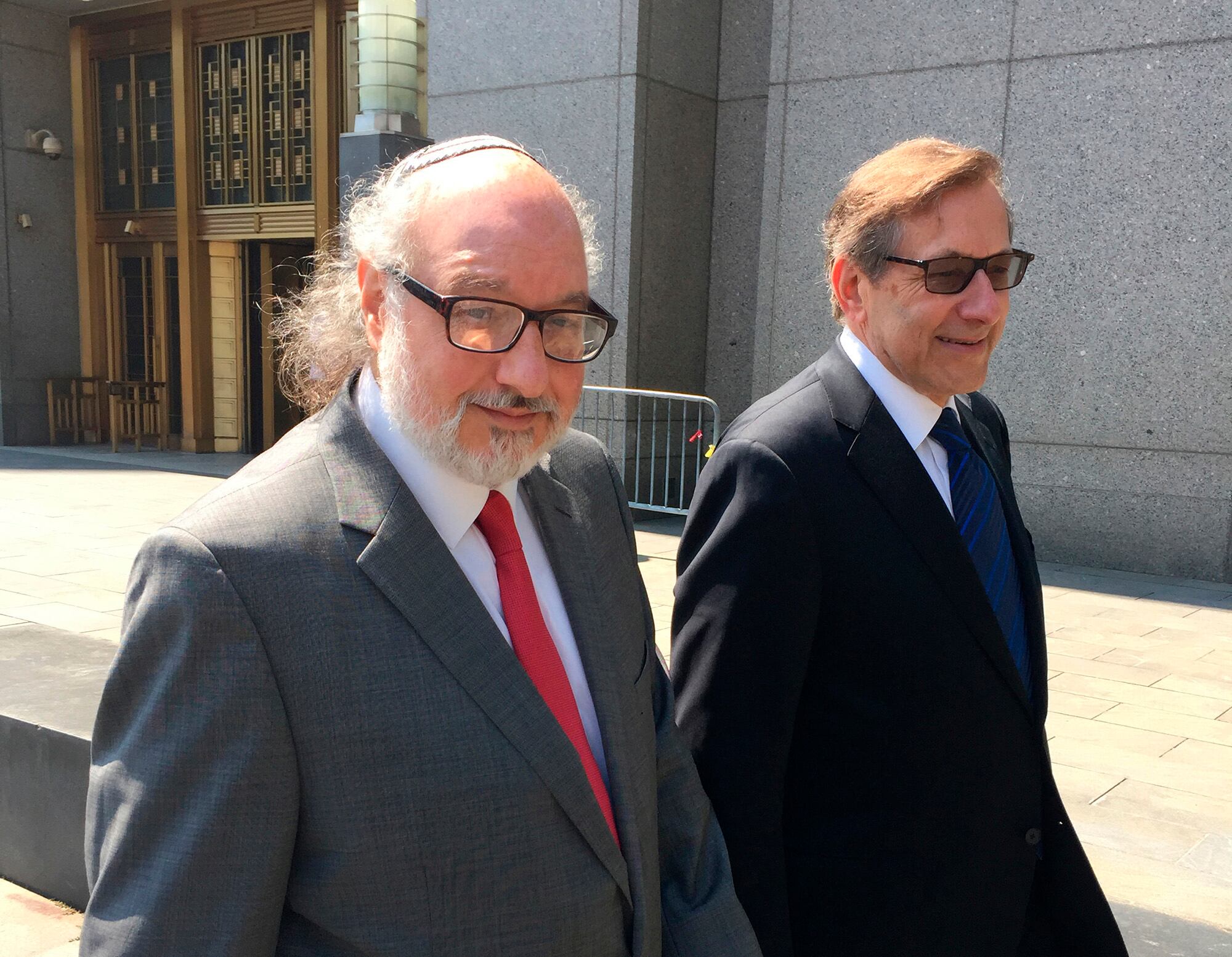 In this July 22, 2016, file photo, convicted spy Jonathan Pollard, left, with his lawyer, Eliot Lauer, leaves federal court in New York following a hearing.