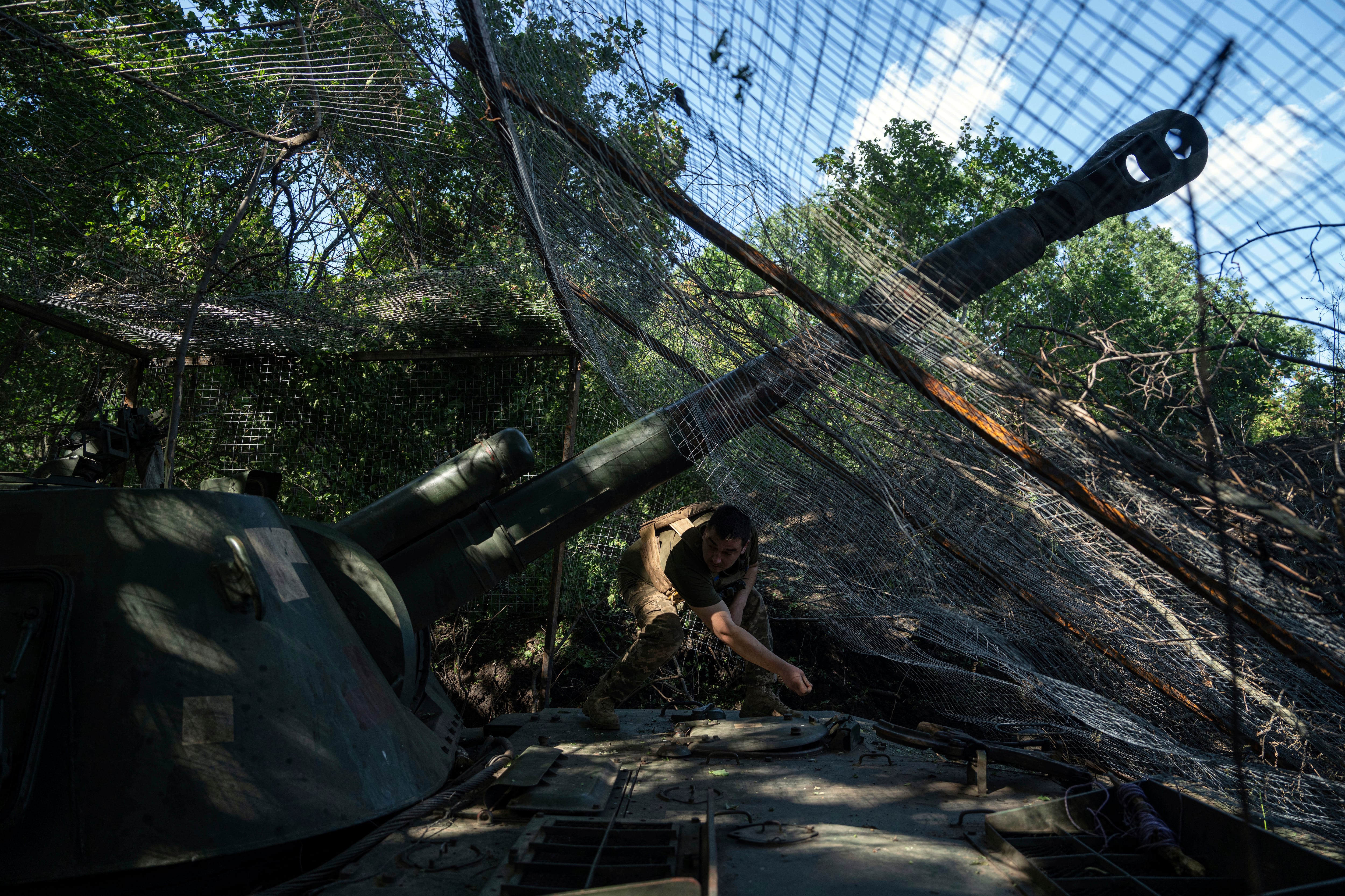 A Ukrainian serviceman of 30th brigade prepares his self propelled artillery to fire towards Russian position in Donetsk region, Ukraine, Tuesday, June 20, 2023.