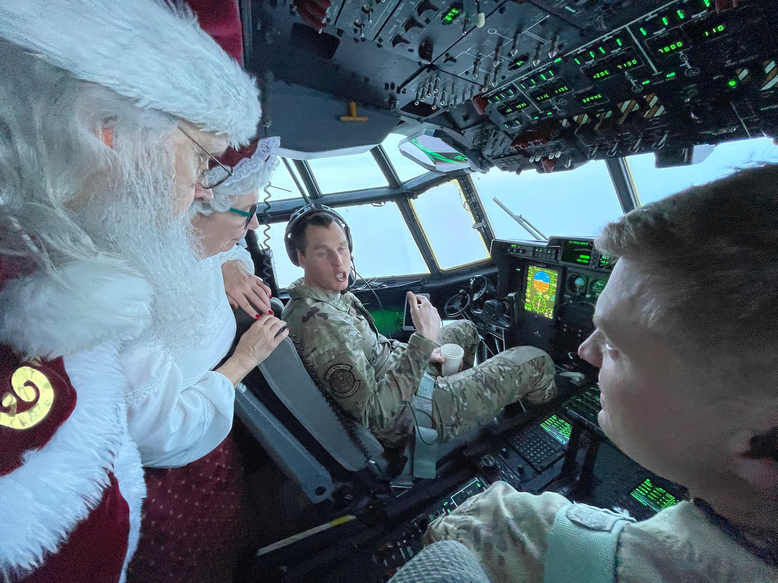 Santa and Mrs. Claus chat with the flight crew of an Alaska National Guard cargo plane while en route to Nuiqsut, Alaska, on Tuesday, Nov. 29, 2022.