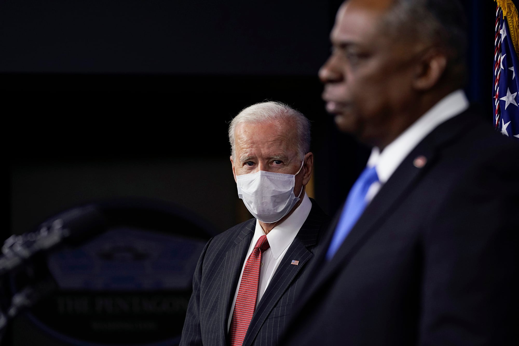 President Joe Biden listens as Secretary of Defense Lloyd Austin speaks at the Pentagon, Wednesday, Feb. 10, 2021, in Washington.