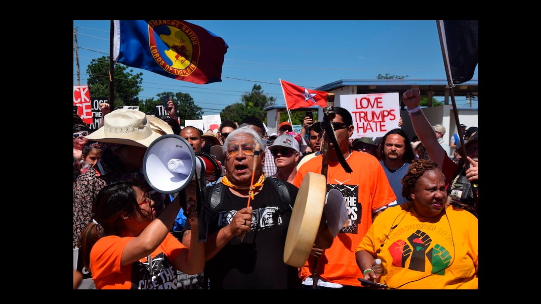 Dr. Cornel Pewewardy beats the drum and leads  protesters as they march along Northwest Ozmun Avenue and onto Sheridan Road to the Fort Sill entry gates, Saturday, July 20, 2019 in Lawton, Okla