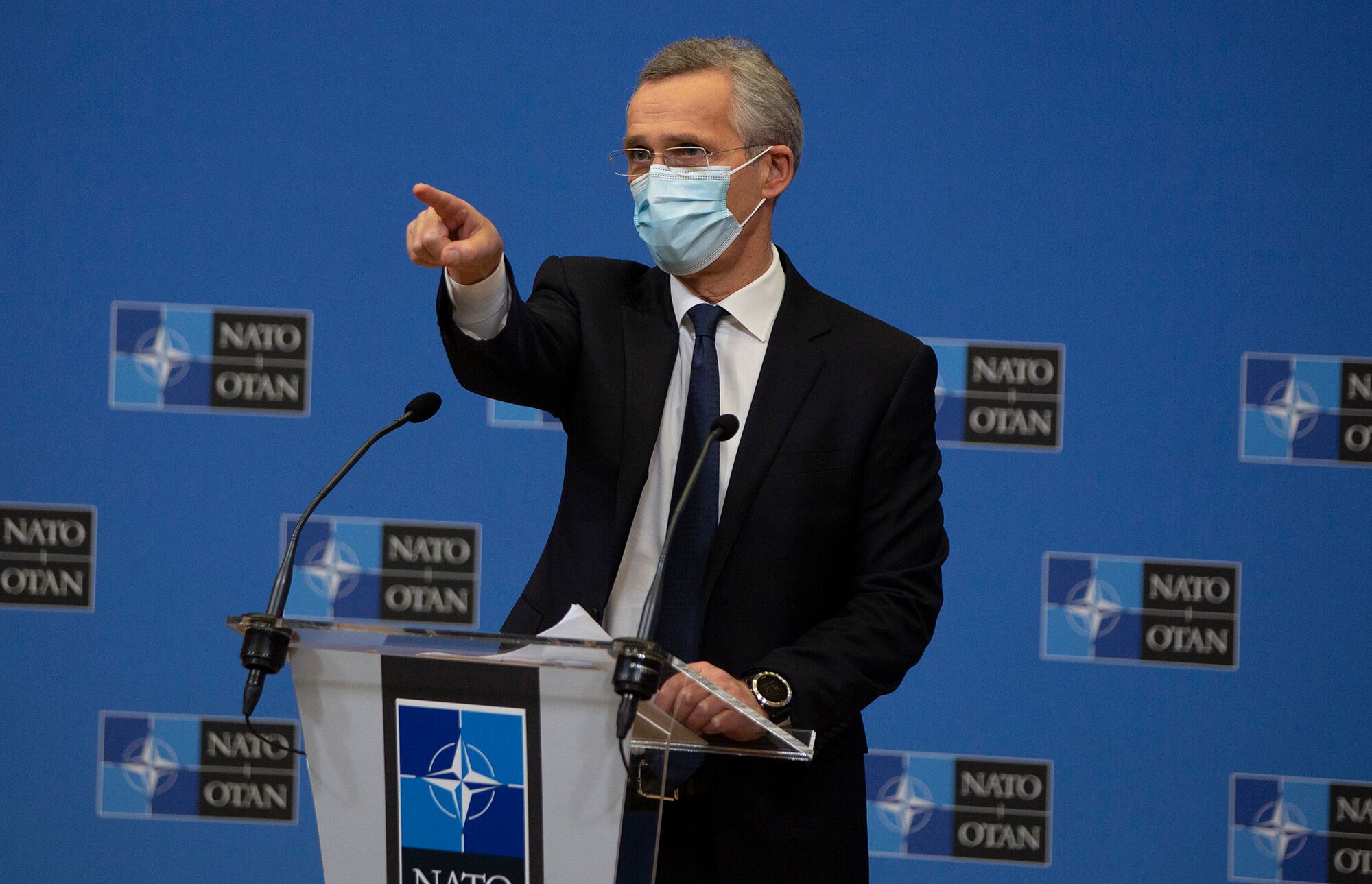 NATO Secretary General Jens Stoltenberg wears a protective face mask as he prepares to speak during a media conference at NATO headquarters in Brussels on Thursday, Feb. 18, 2021.