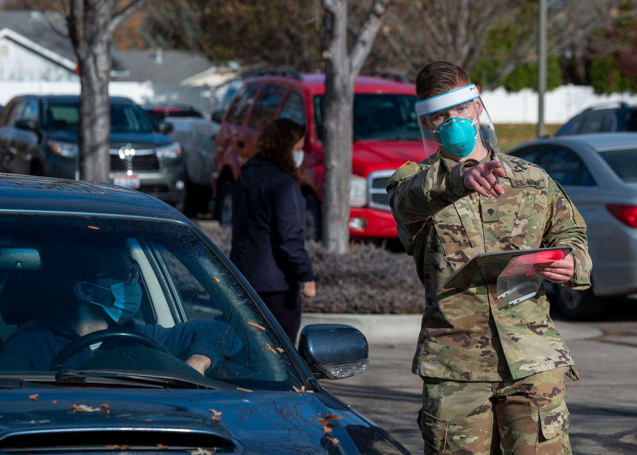 An Idaho Army National Guardsman directs a driver during a COVID-19 screening at Saint Alphonsus Medical Group Meridian Health Plaza Urgent Care, Meridian, Idaho, Nov. 19, 2020.