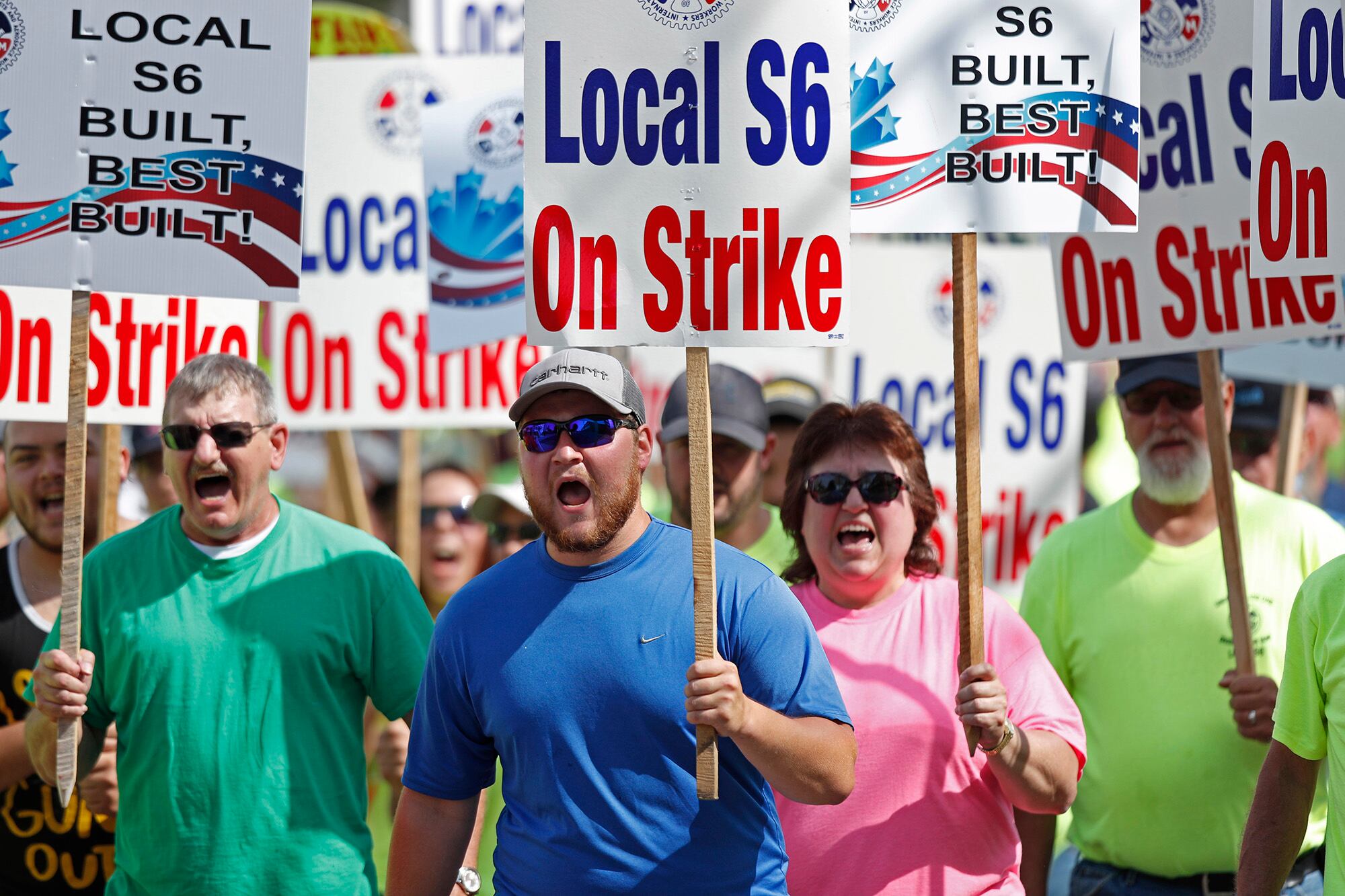 In this July 25, 2020 file photo, striking Bath Iron Works shipbuilders march in solidarity in Bath, Maine.