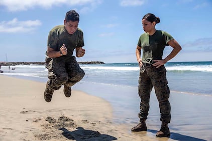 U.S. Marine Sgt. Roxanne Gorostieta motivates a fellow Marine during a physical training session at Del Mar Beach on Marine Corps Base Camp Pendleton, Calif., Aug. 5, 2020.