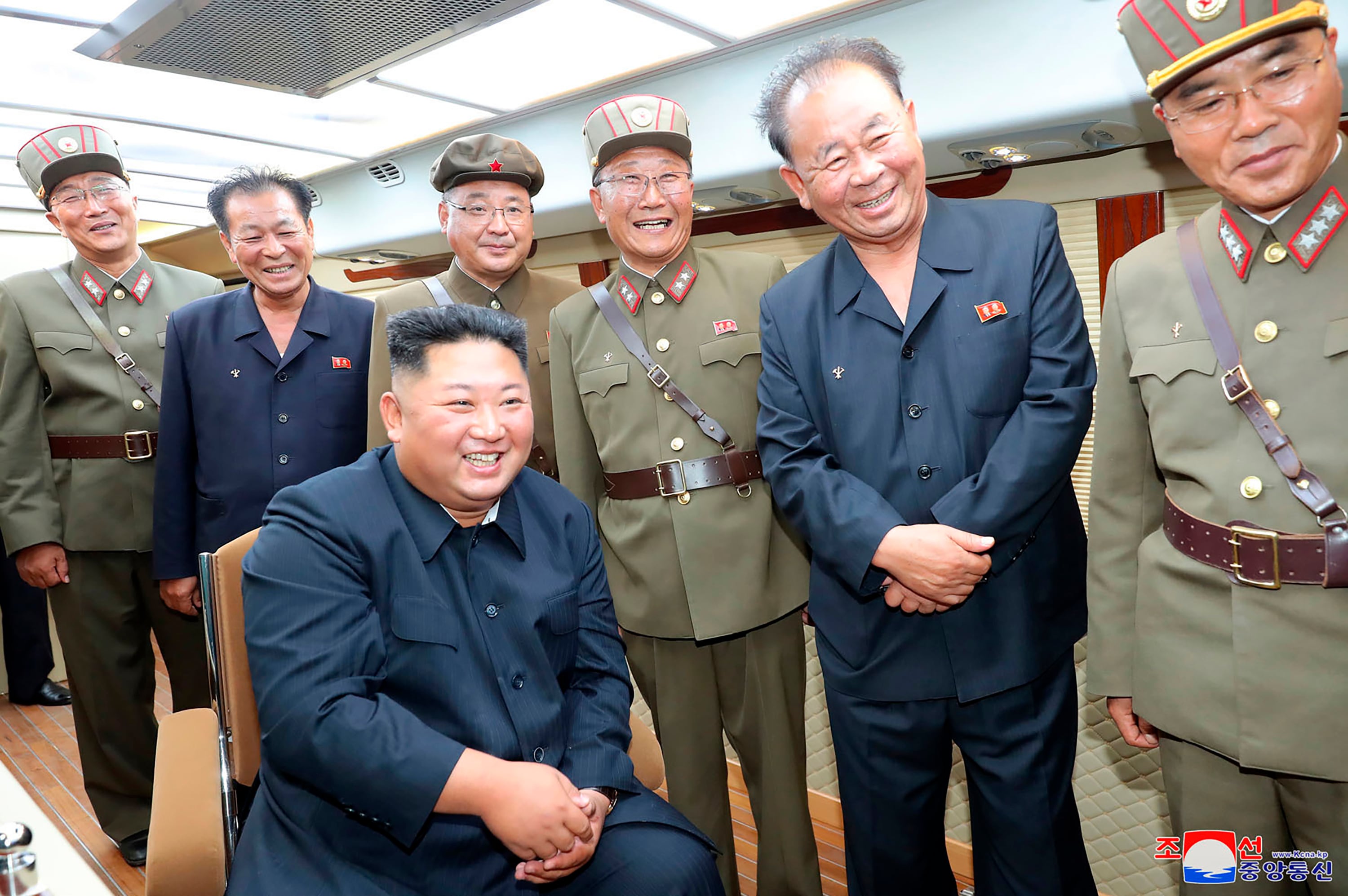 In this Saturday, Aug. 10, 2019, photo provided by the North Korean government, North Korean leader Kim Jong Un, sitting, watches test firings of short-range weapons at an undisclosed location in North Korea.