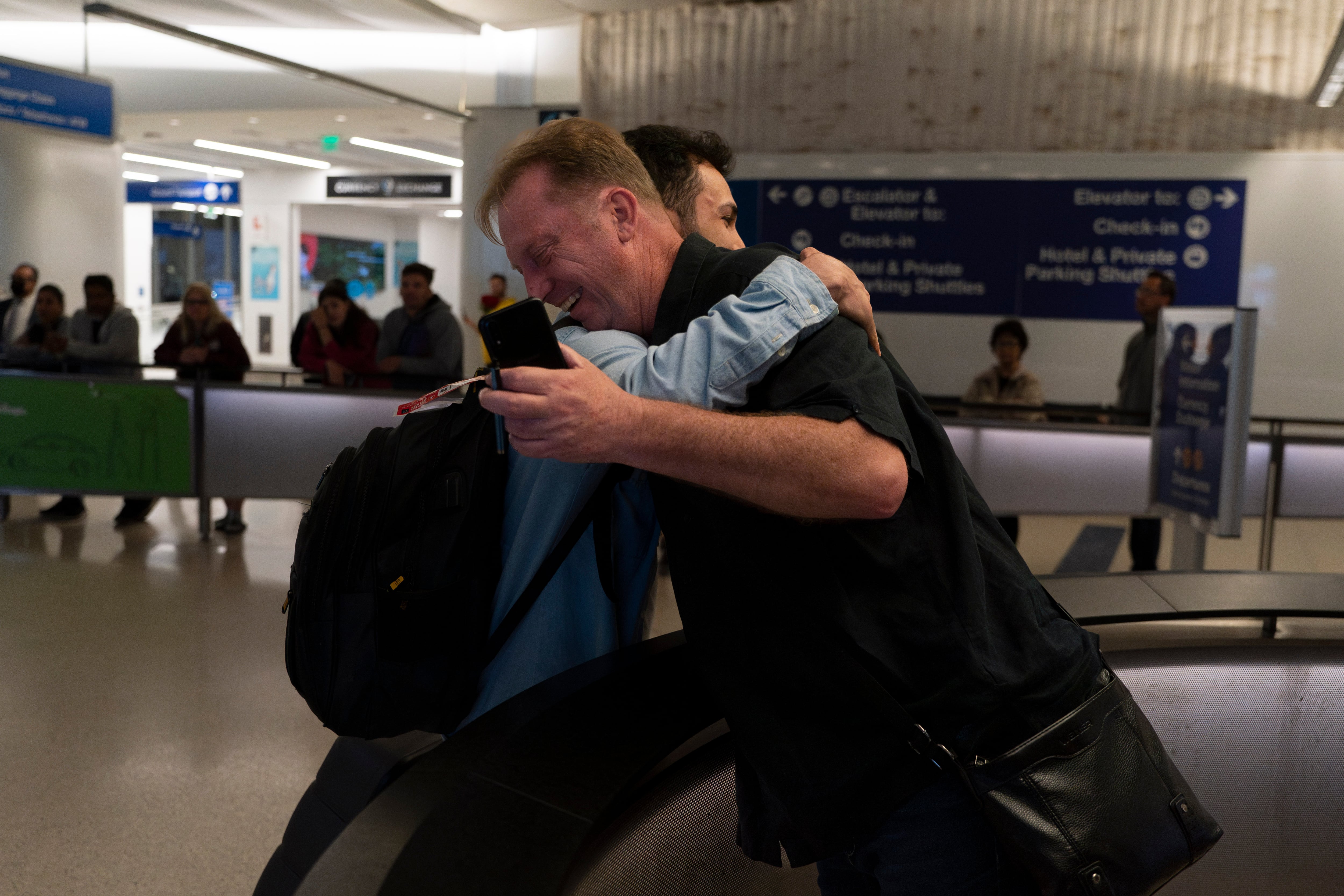 Michael White, a Navy veteran who was jailed in Iran for several years on spying charges, right, hugs Michael's former fellow prisoner and Iranian political activist Mahdi Vatankhah at the Los Angeles International Airport in Los Angeles, Thursday, June 1, 2023.