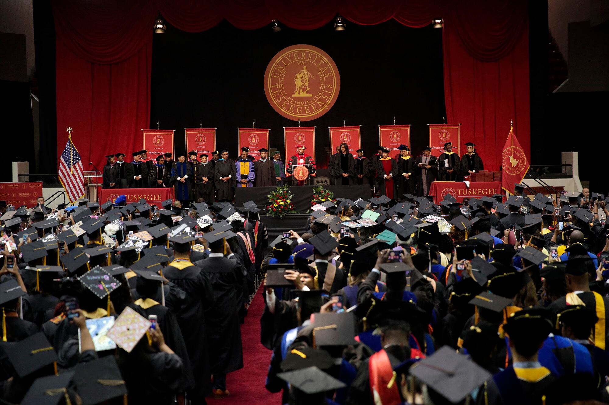 First lady Michelle Obama waits on stage before she he delivers the commencement address at Tuskegee University, May 9, 2015, in Tuskegee, Ala.