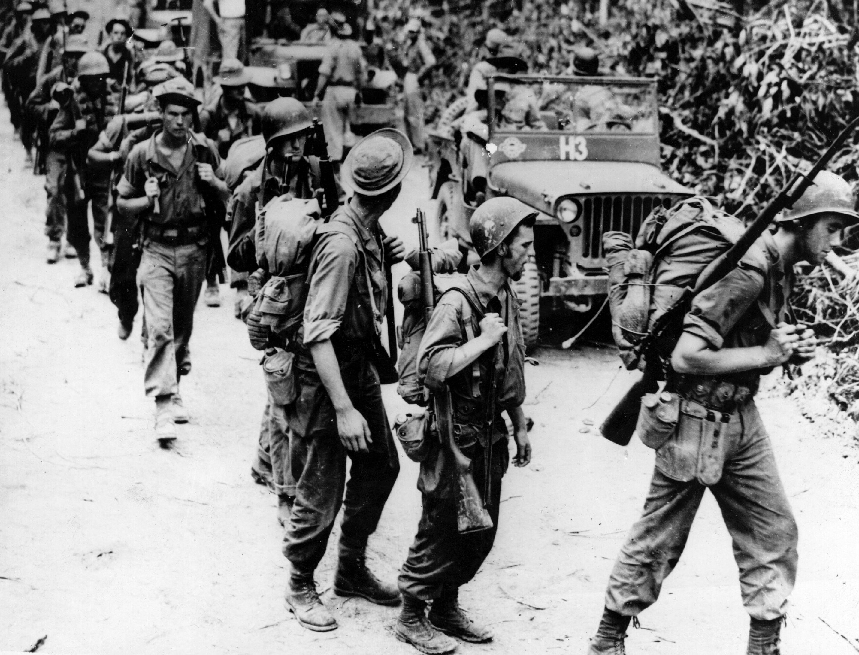 American soldiers, members of Gen. Frank Merrill's 'marauders', with trained Chinese soldiers on a jungle trail in Burma circa 1940.