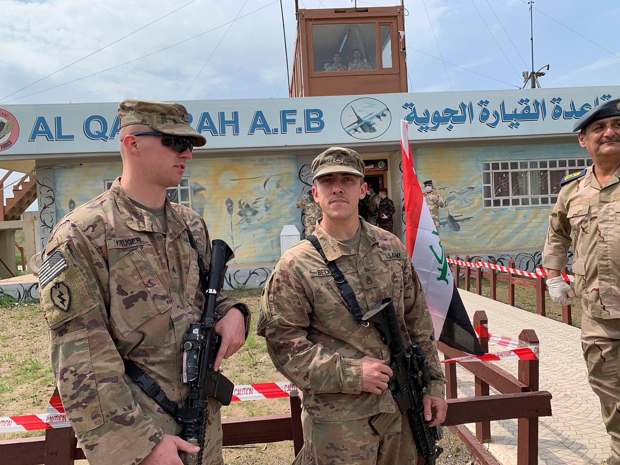 In this March 27, 2020, file photo, U.S. soldiers stand guard during the hand over ceremony of Qayyarah Airfield, Iraqi Security Forces, in the south of Mosul, Iraq.