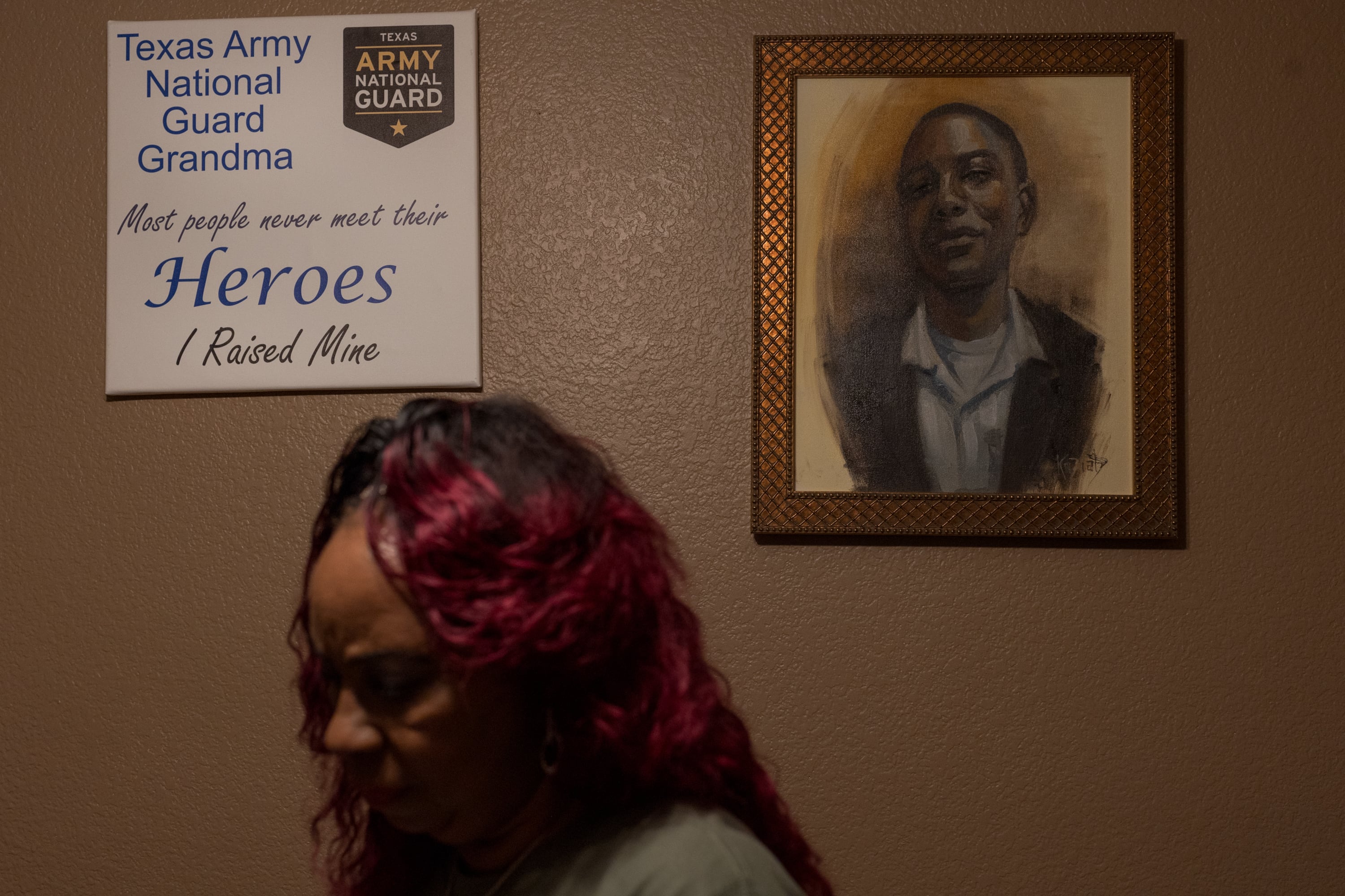 Jo Ann Johnson goes through awards given to her grandson Bishop Evans, who died while working on Operation Lone Star, inside of her home in Arlington on Dec. 7, 2022.