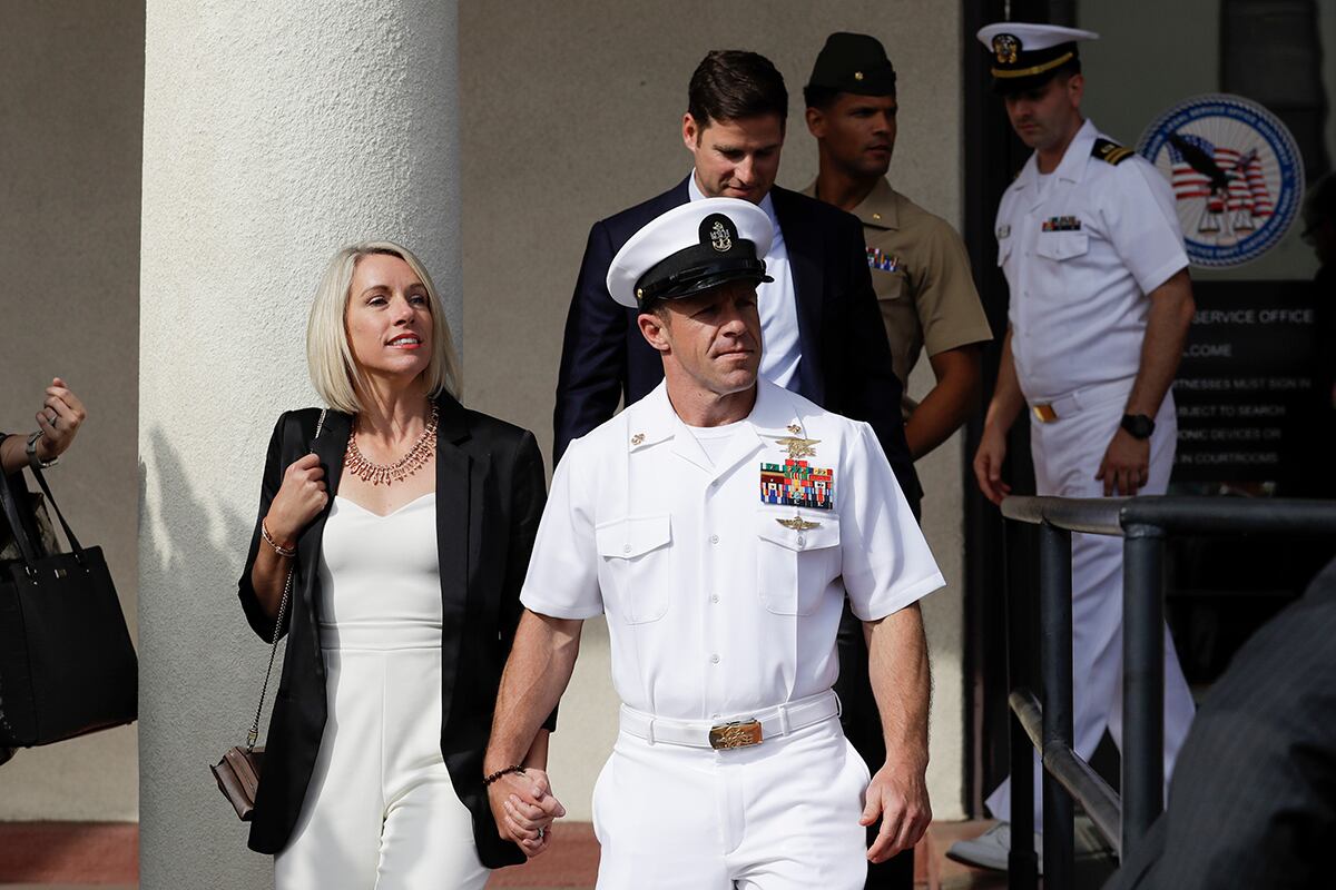 Navy Special Operations Chief Edward Gallagher, center, walks with his wife, Andrea Gallagher, as they leave a military court on Naval Base San Diego, Tuesday, July 2, 2019, in San Diego.