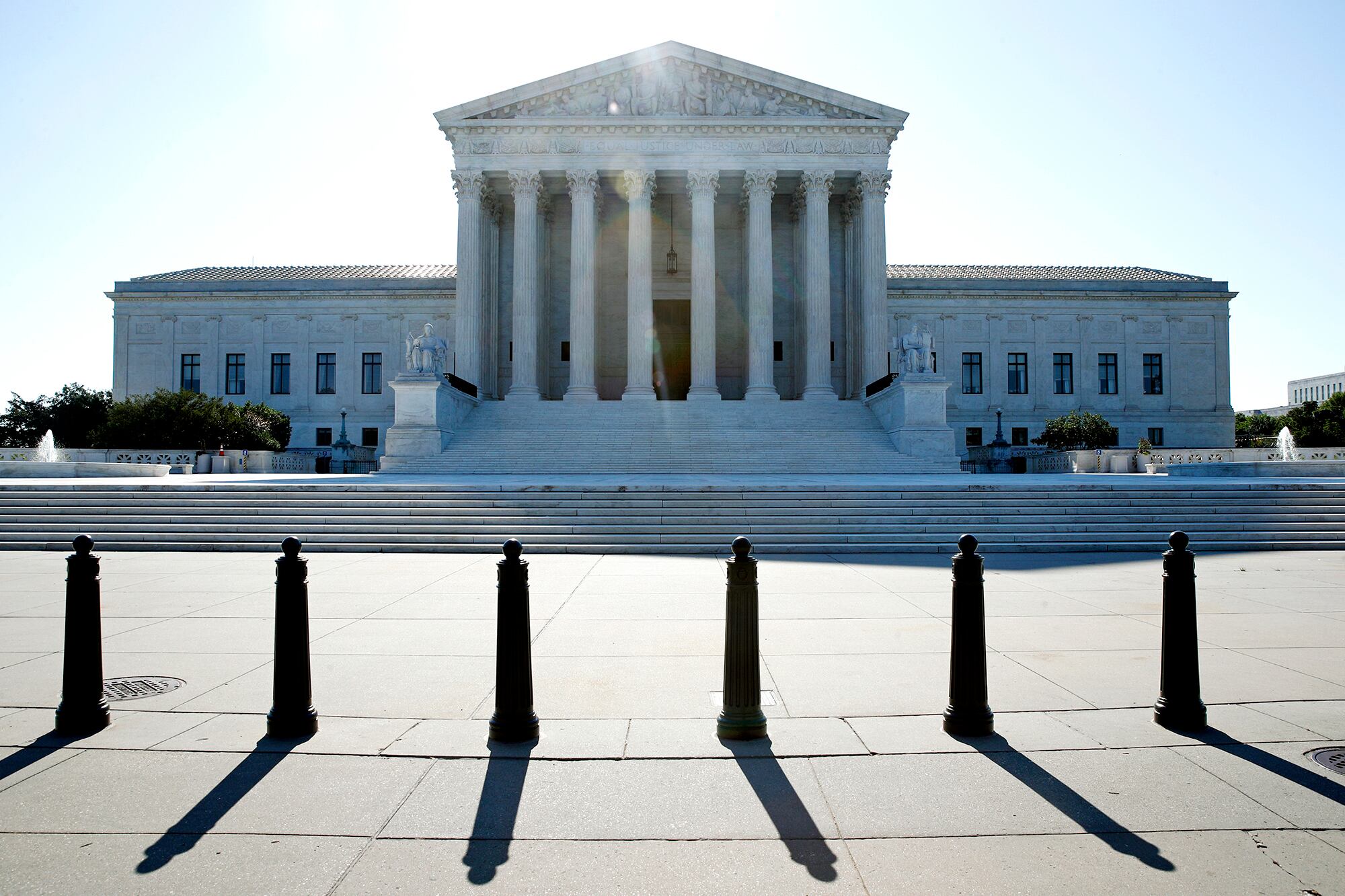 The sun rises behind the Supreme Court on Capitol Hill in Washington, Monday, June 29, 2020.